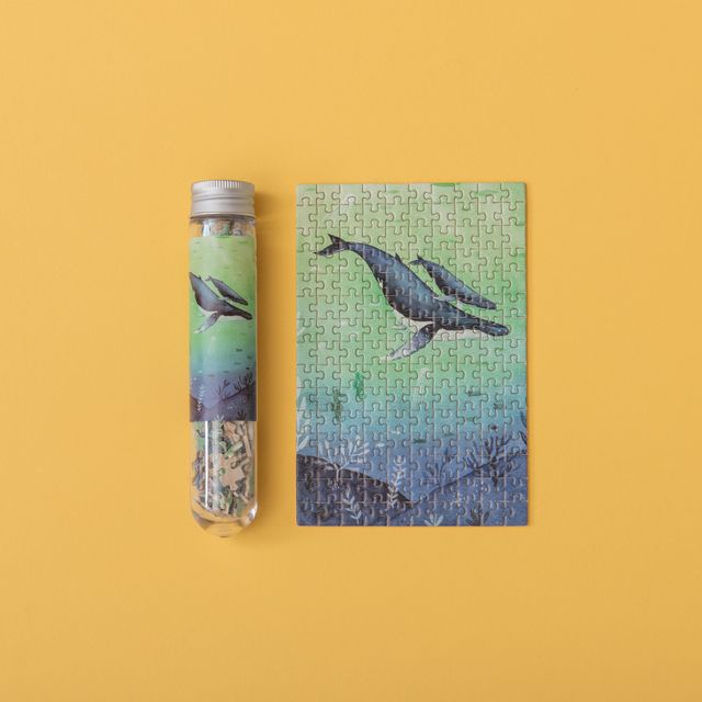 Jigsaw puzzle with whale design on a yellow background