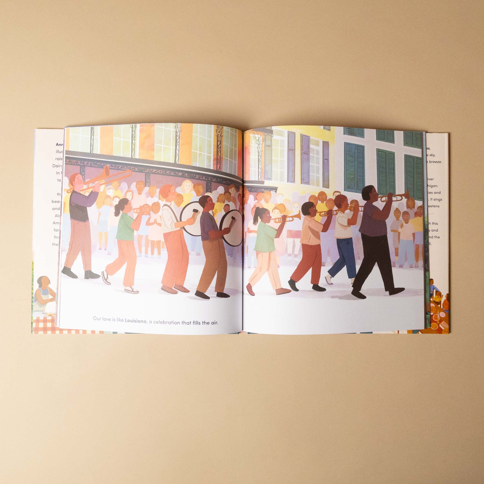 Open 50-states-of-love book showing illustrations of people playing instruments on a beige background
