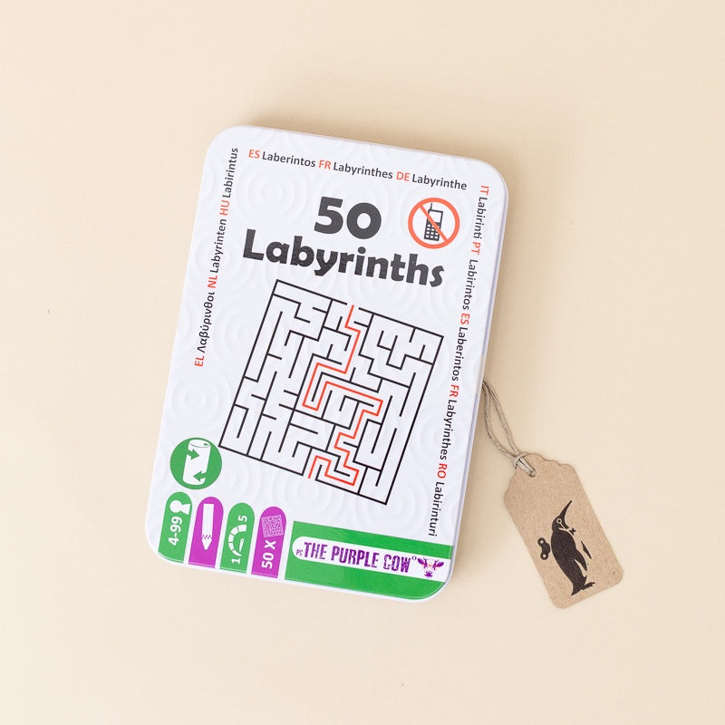A square metal tin labeled '50 Labyrinths' shown on a warm beige background with a small kraft paper tag attached by a string.