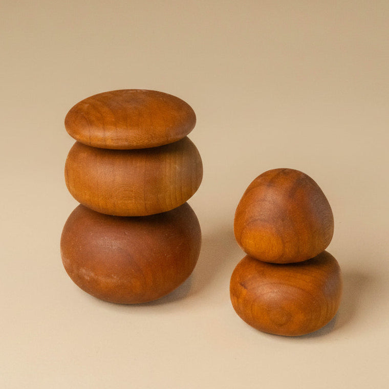 Set of wooden sculptures on a beige background with a tag.
