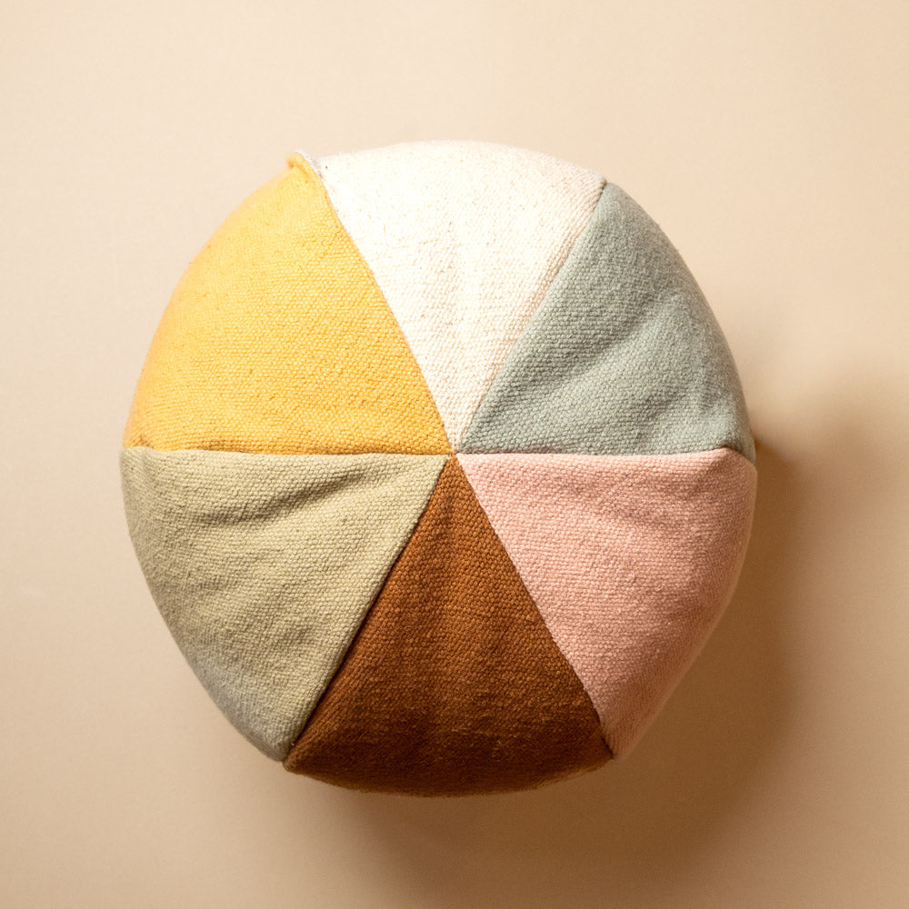 Playful-Ball-Cushion Round pillow with geometric color pattern on a beige background