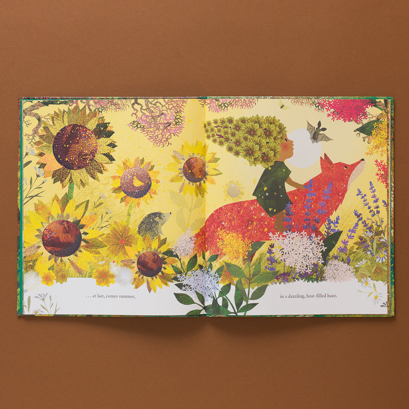 The-Green-Child-Book open page to illustration of a child on a fox amongst sunflowers