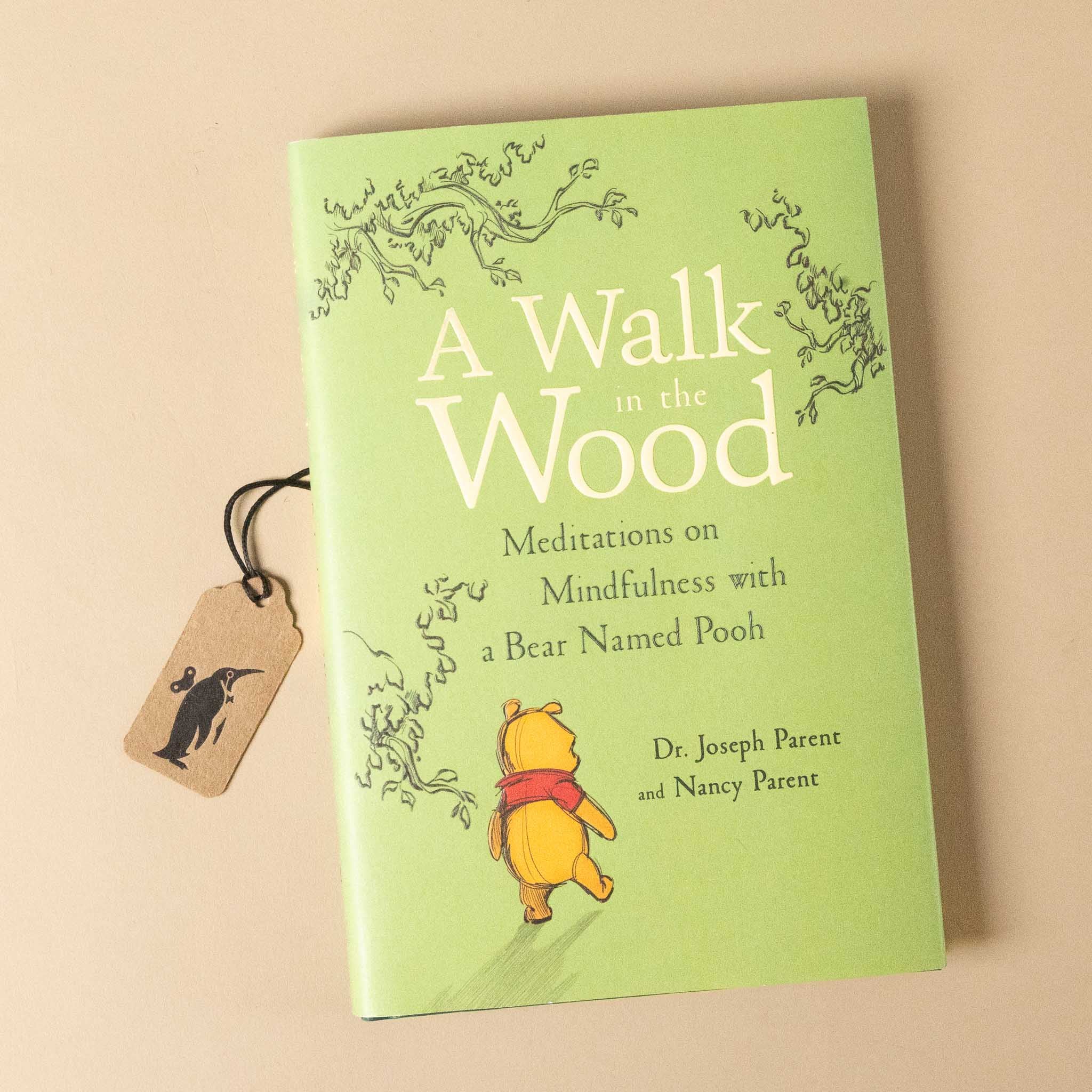 Book titled 'A Walk in the Wood' with winnie the pooh bear illustration on a beige background