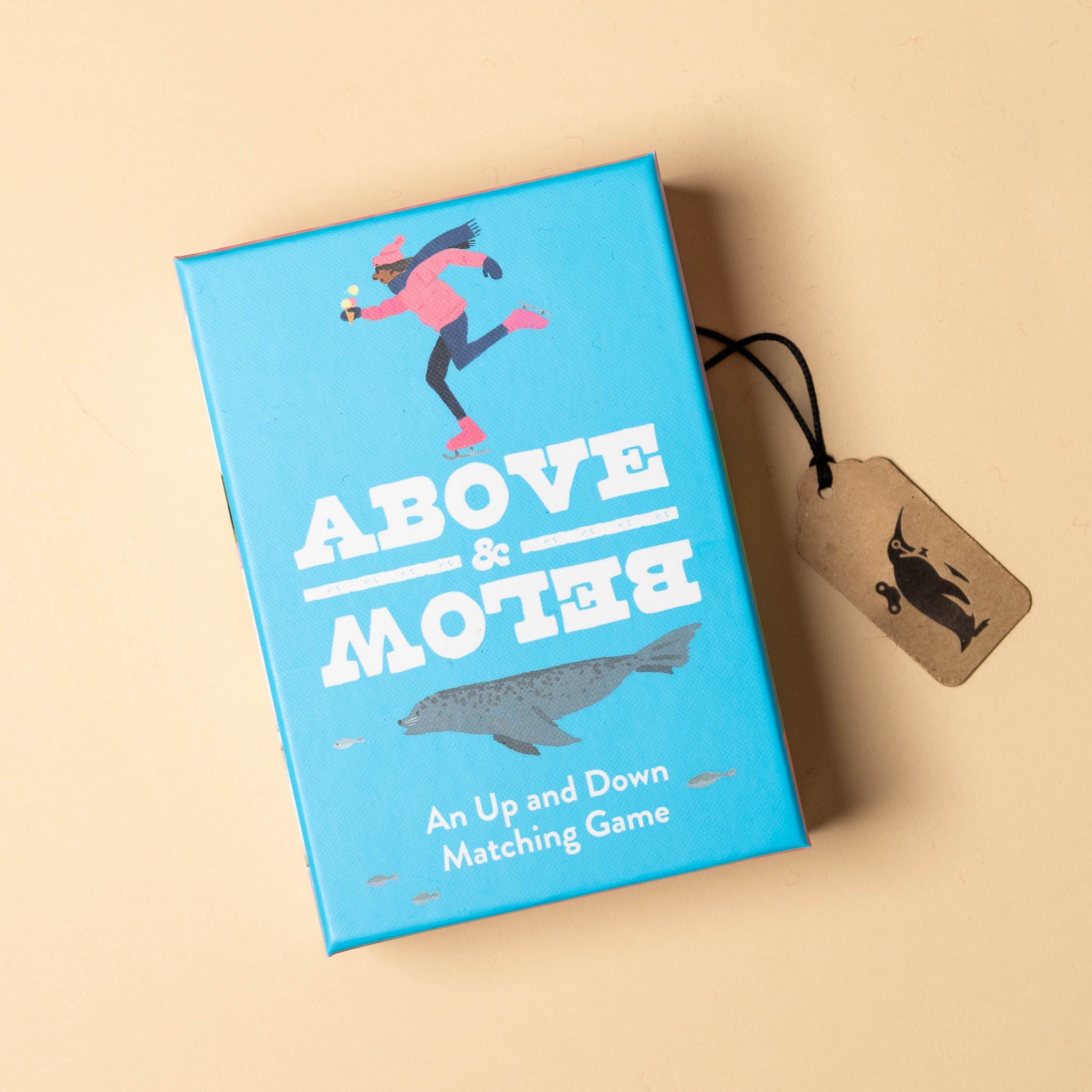 Blue game box with 'above-and-below-an-up-and-down-memory-game' text and a tag on a beige background