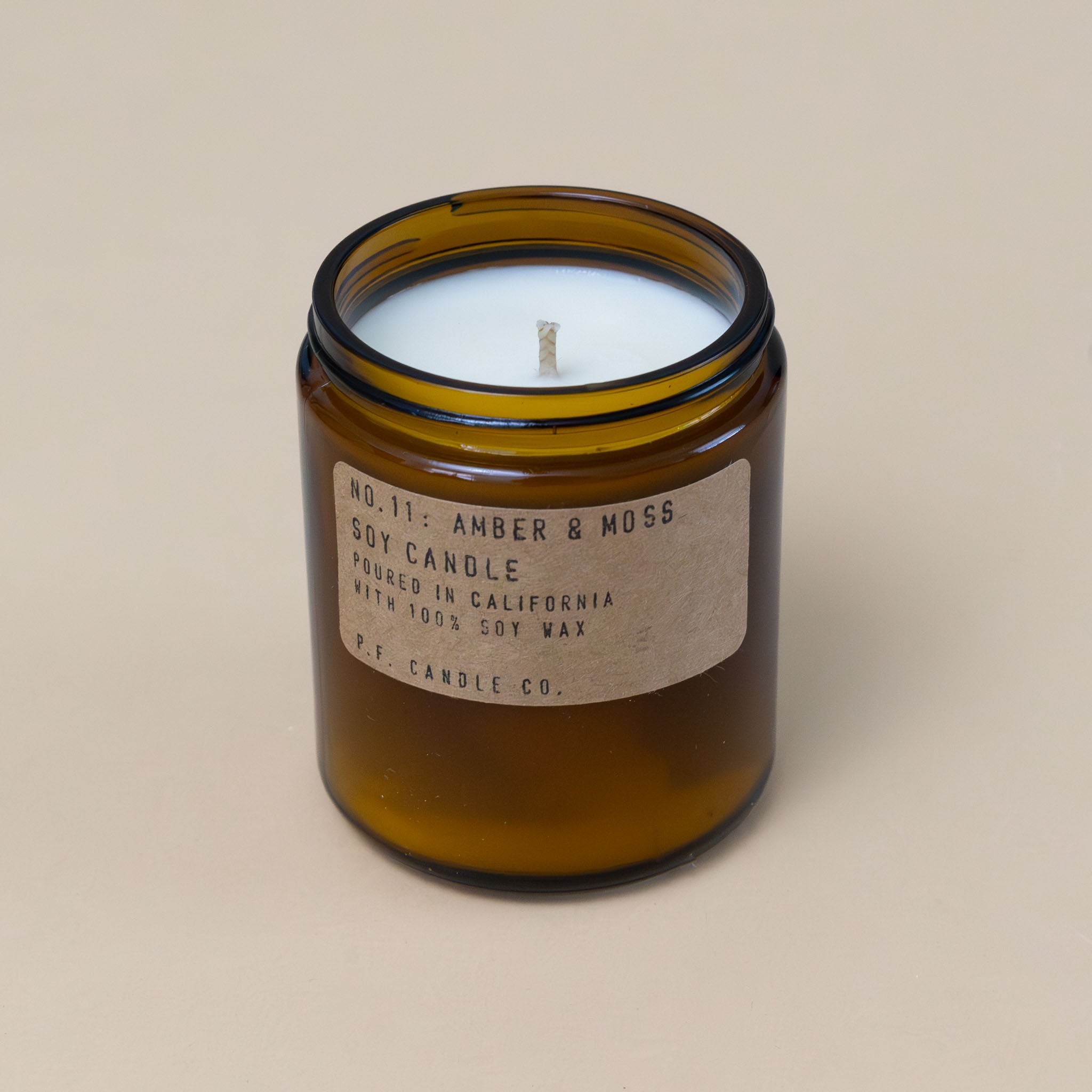 amber-and-moss-candle-in-brown-apothecary-jar-with-brass-lid