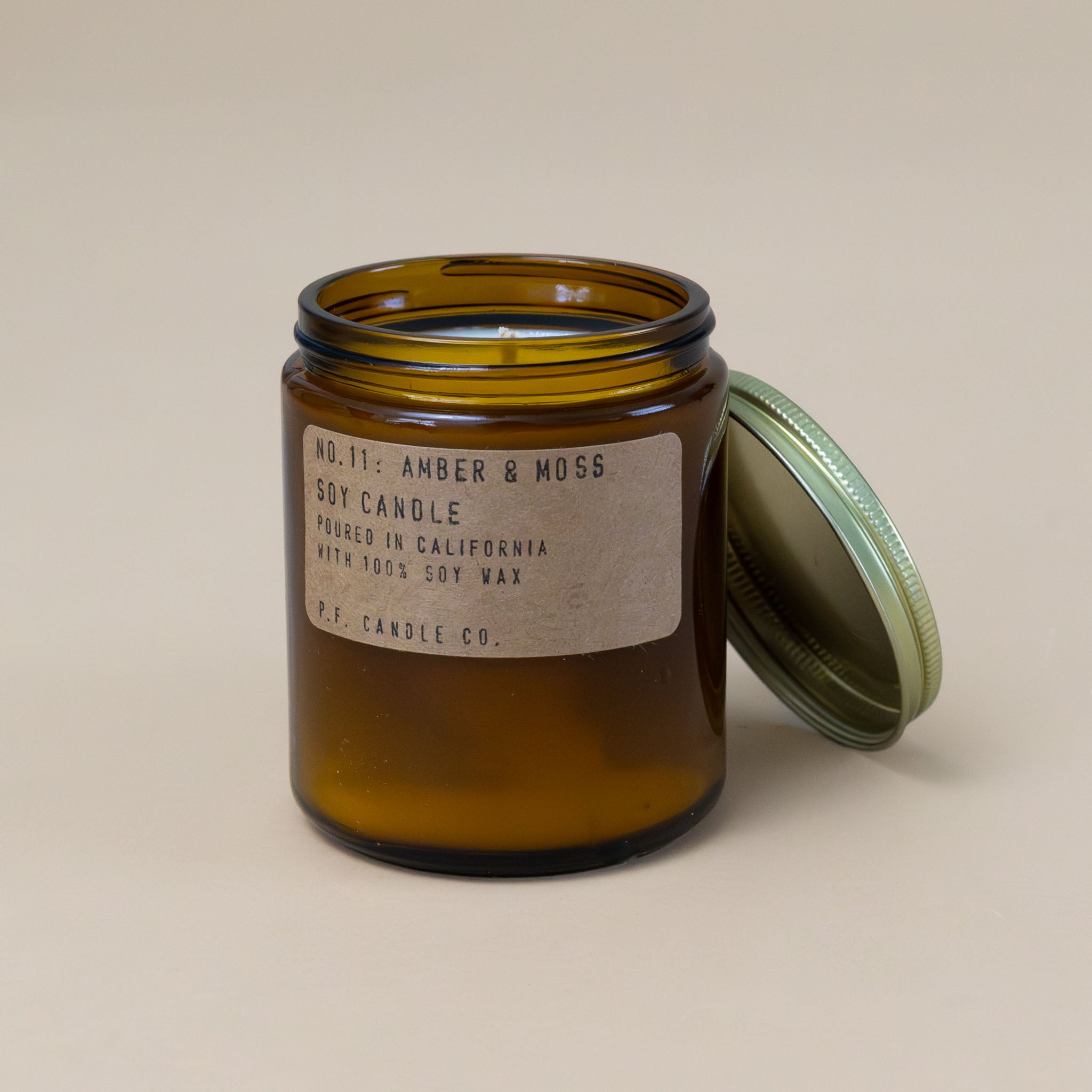 amber-and-moss-candle-in-brown-apothecary-jar-with-brass-lid