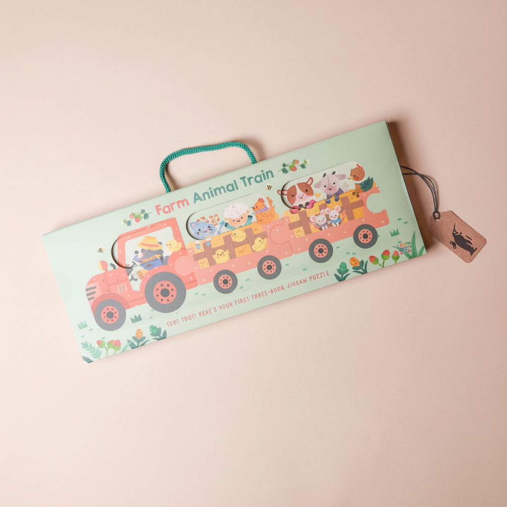 Children's puzzle with a train design featuring farm animals on a pink background