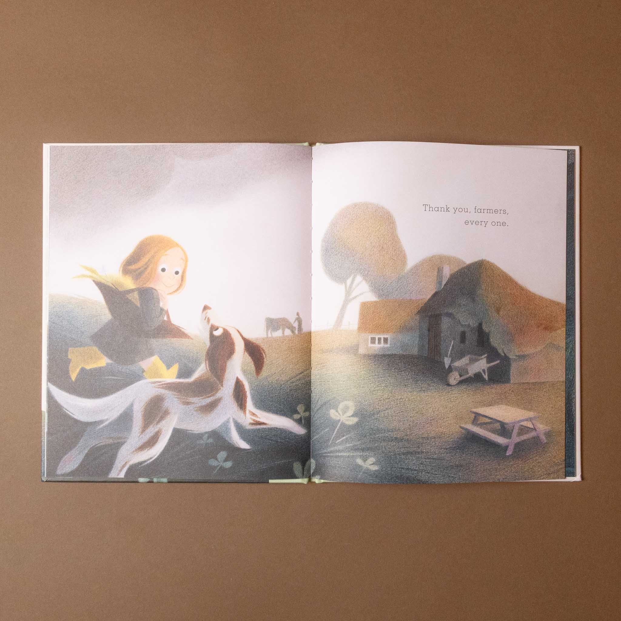 Open apple-cake-a-gratitude with illustrations of a girl and dog in a pastoral scene on a brown background