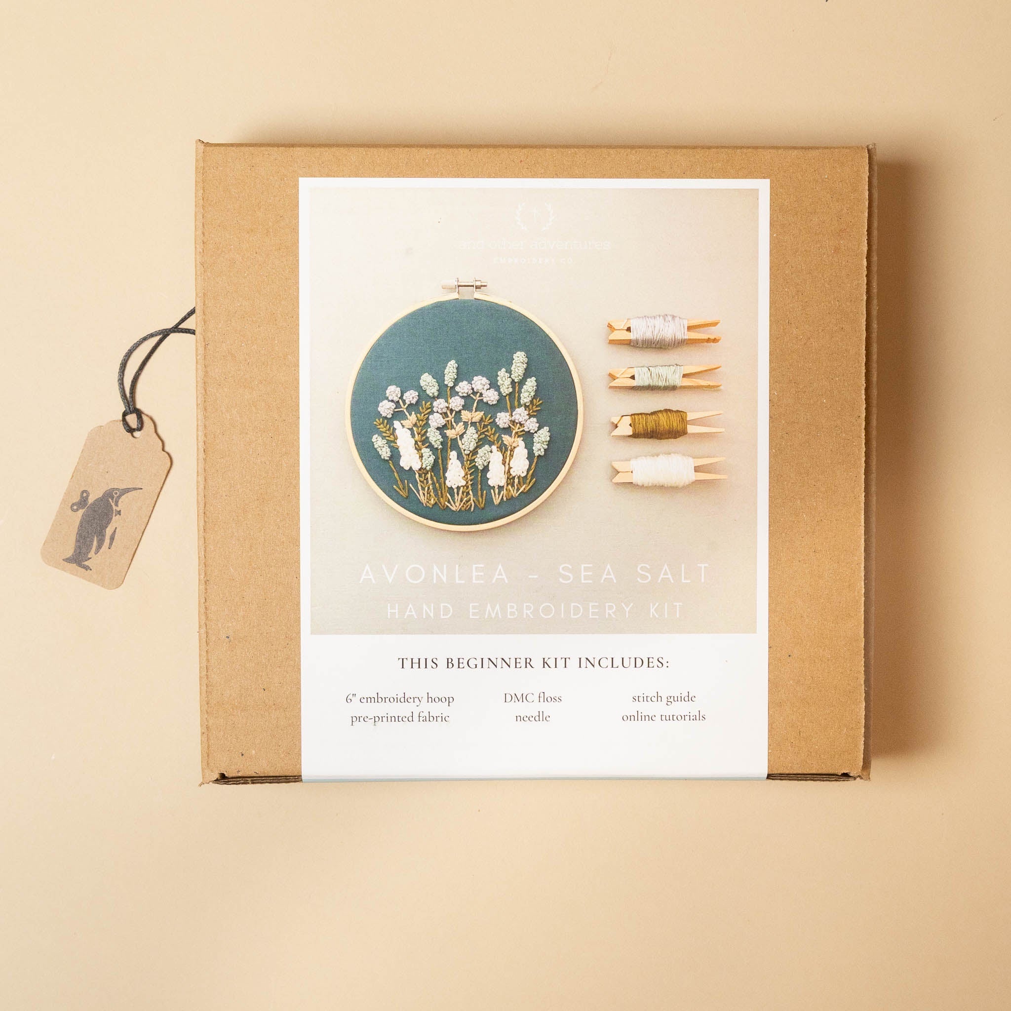 avonlea-embroidery-kit-sea-salt packaging with an embroidered hoop and thread on a beige background