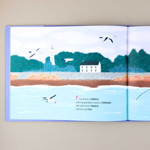 open-book-showing-page-with-illustraion-of-a-beach-with-house-and-lighttower-and-seagulls