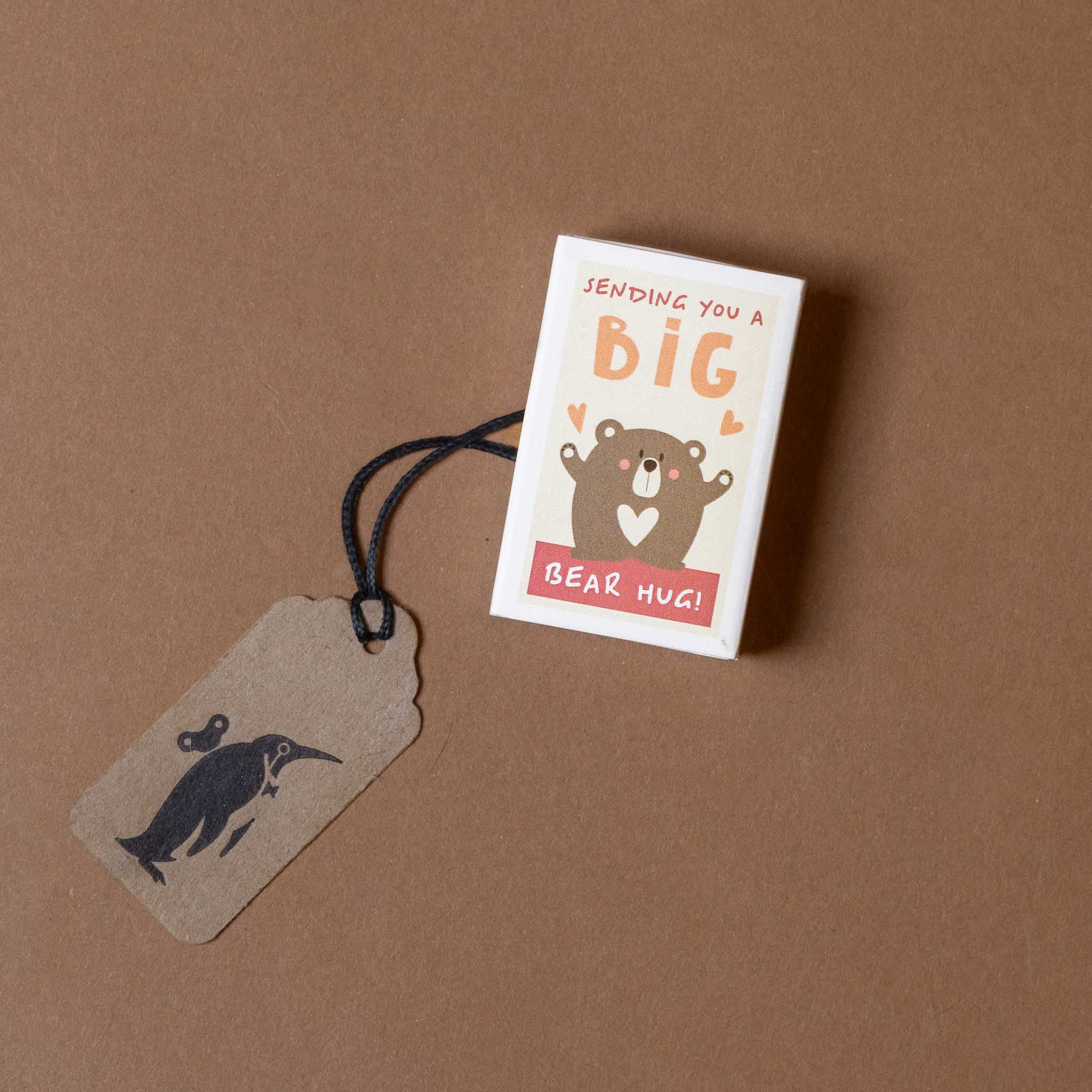 Card with bear illustration and tag on a brown background