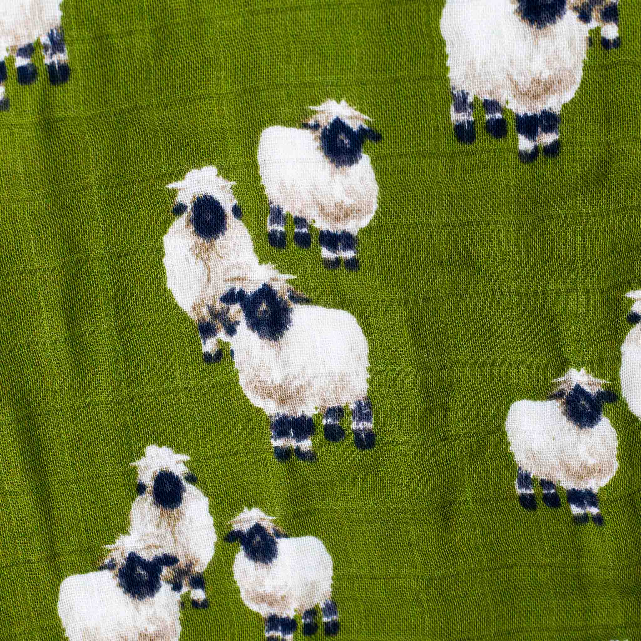 detail-of-dark-green-muslin-fabric-with-valais-sheep-pattern