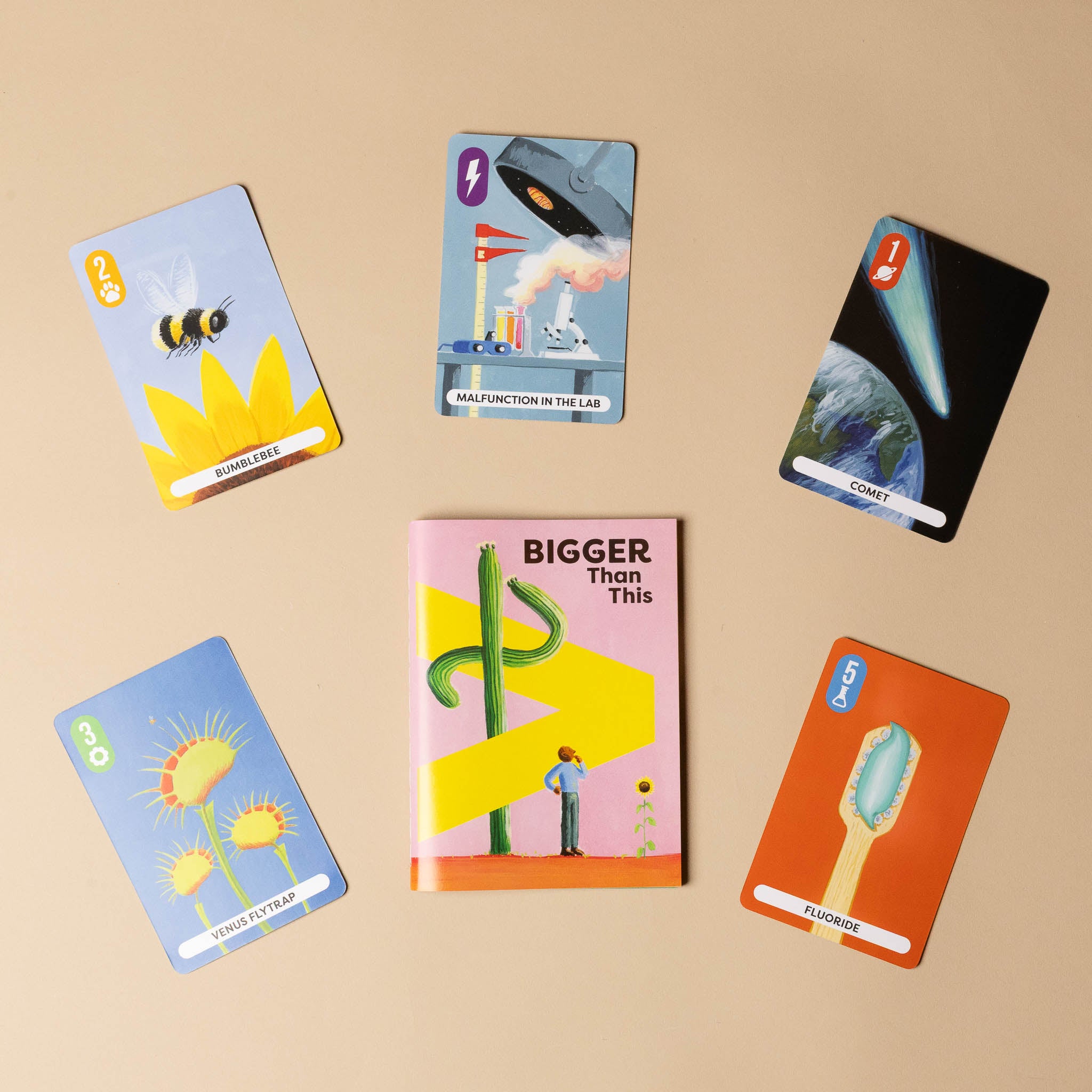 Colorful bigger-than-this-card-game on a beige background