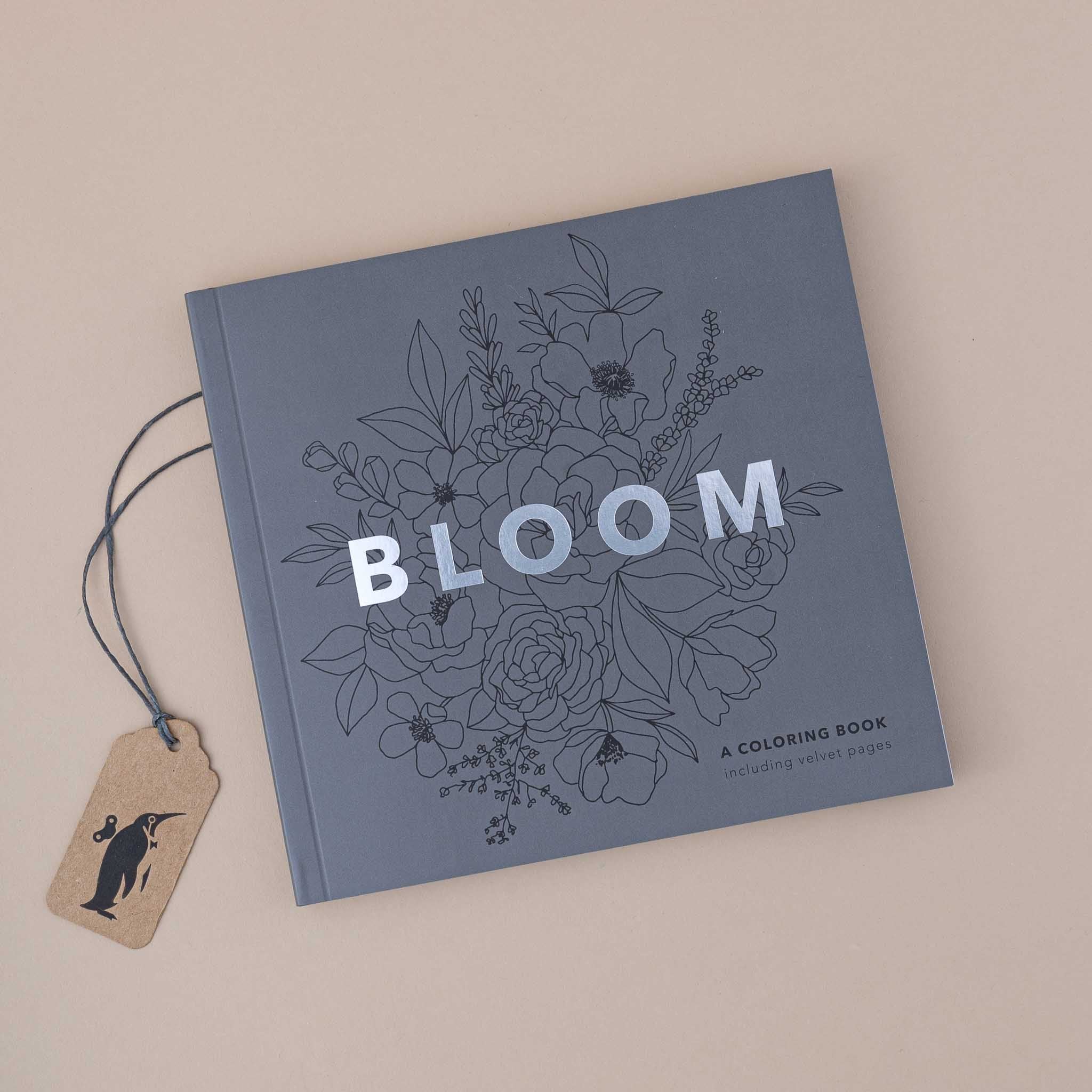 Coloring book titled 'Bloom' with floral designs on a beige background