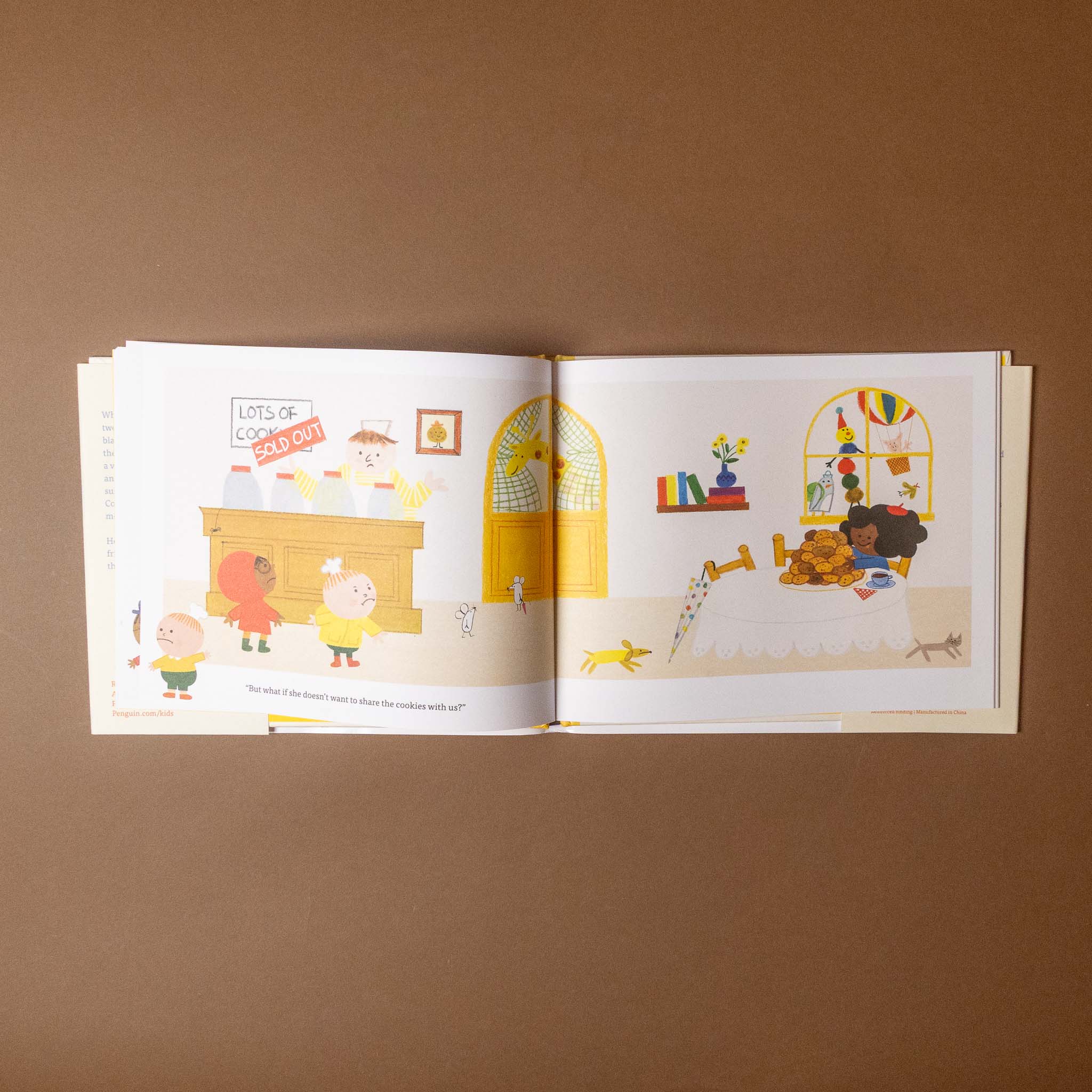 Open bookie-and-cookie-turn-the-page-book with colorful illustrations on a brown background