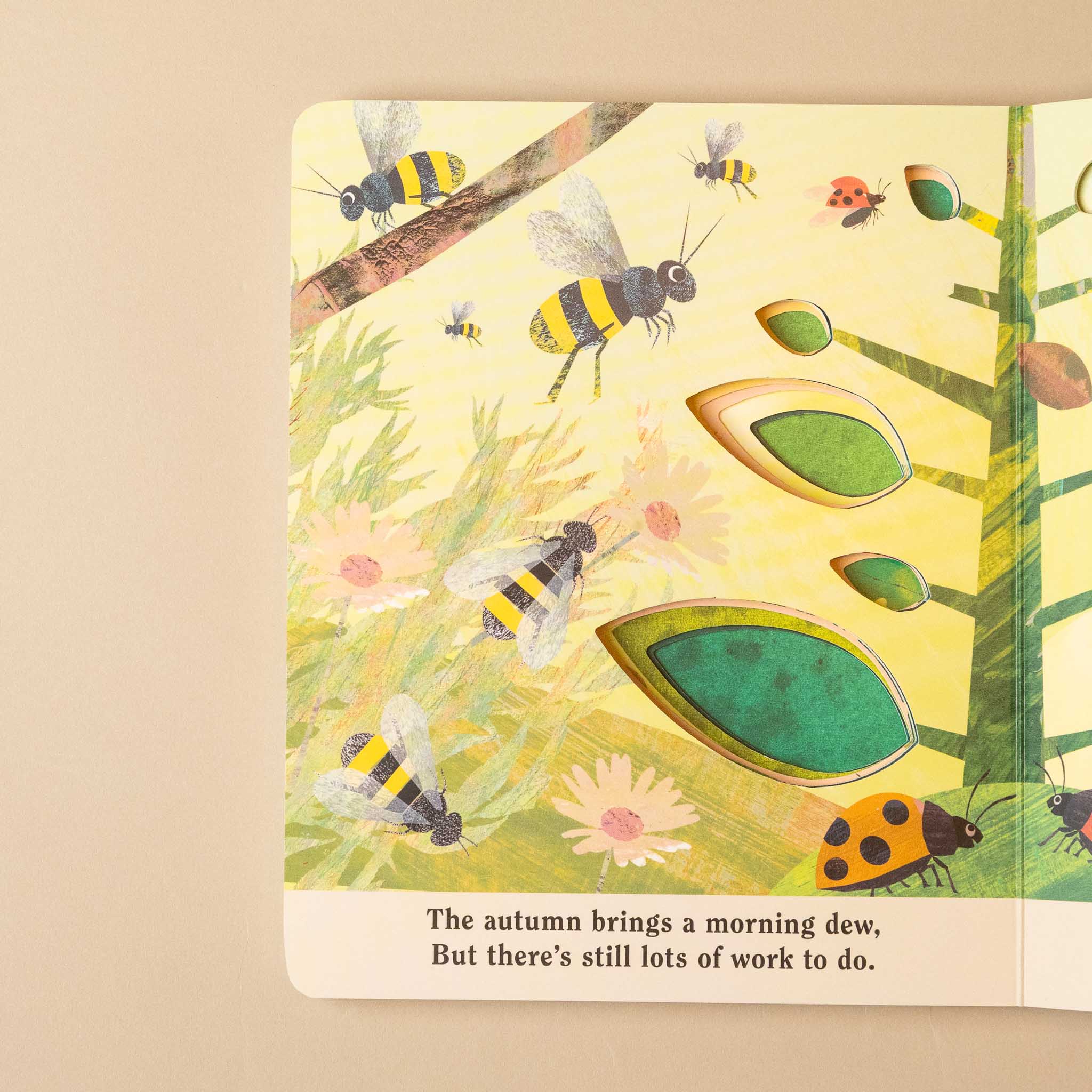 bugs-a-peek-through-board-book Illustration of bees and a ladybug on a leaf with a quote about autumn.
