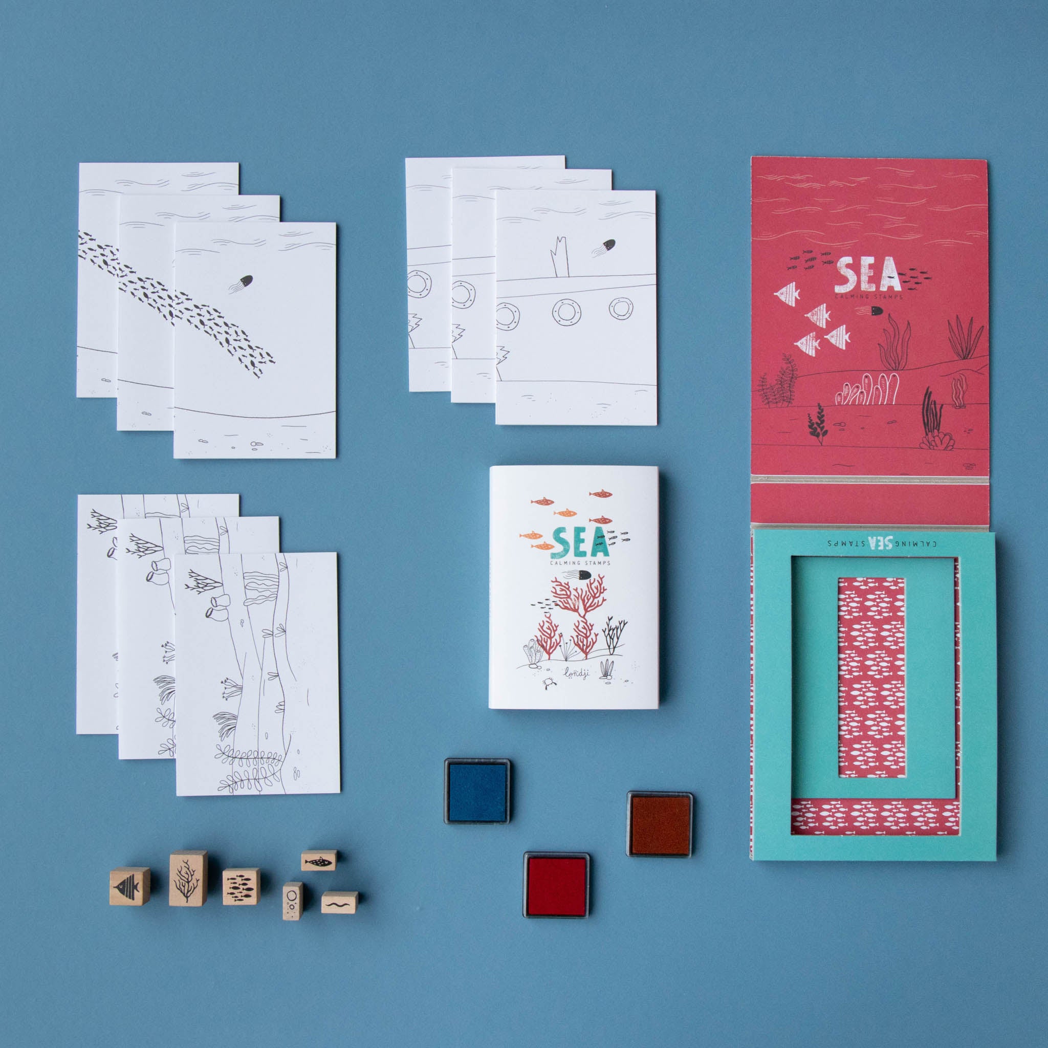calm-stamps-under-the-sea-box-with-fish-and-coral-stamps-and-ink-pads-in-blue-red-and-orange