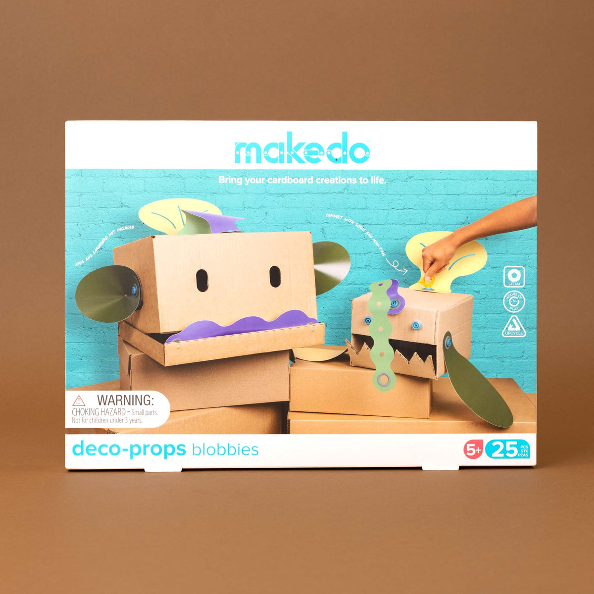 Blobbies toy kit box, featuring cardboard robot and monster creations, shown on a solid brown background.