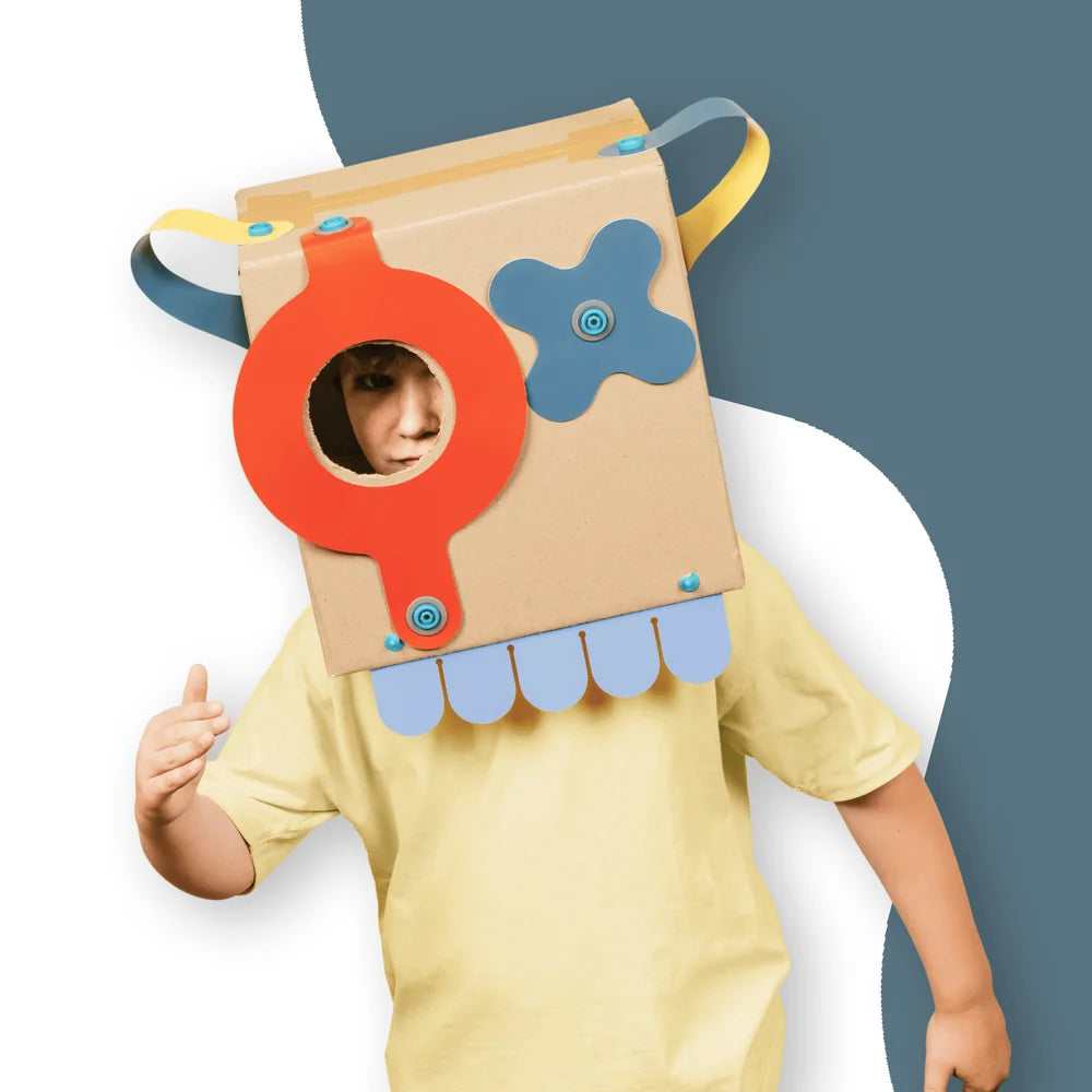 Child wearing a colorful cardboard costume with a blue and orange design on a white background
