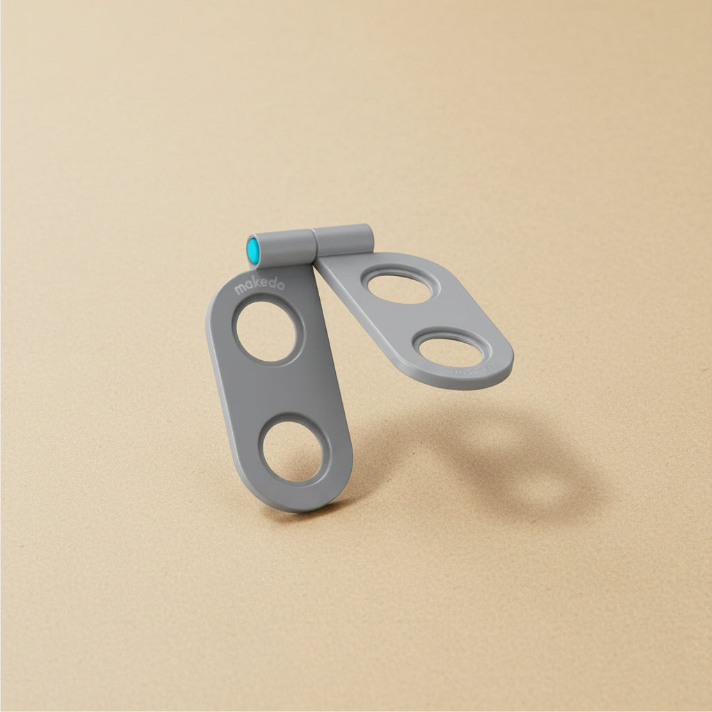 Gray metal clip with a blue accent on a tan background