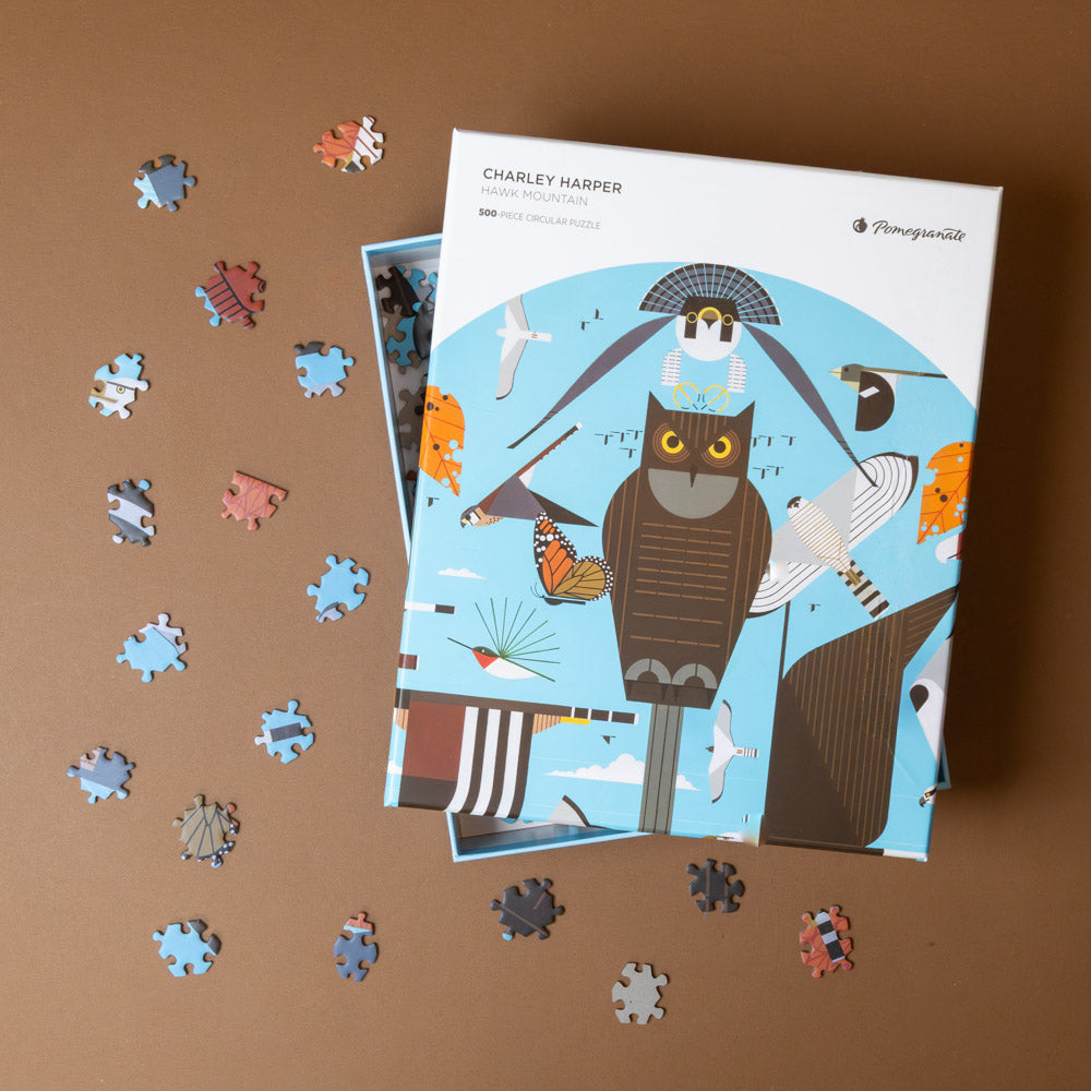 Puzzle with pieces and packaging on a brown background