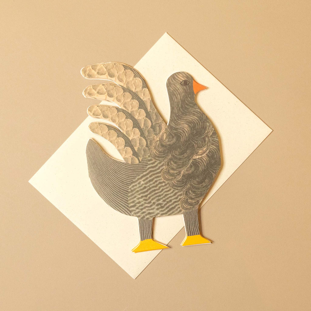 A decorative paper cutout of a turkey standing on a white diamond-shaped card against a warm beige background.