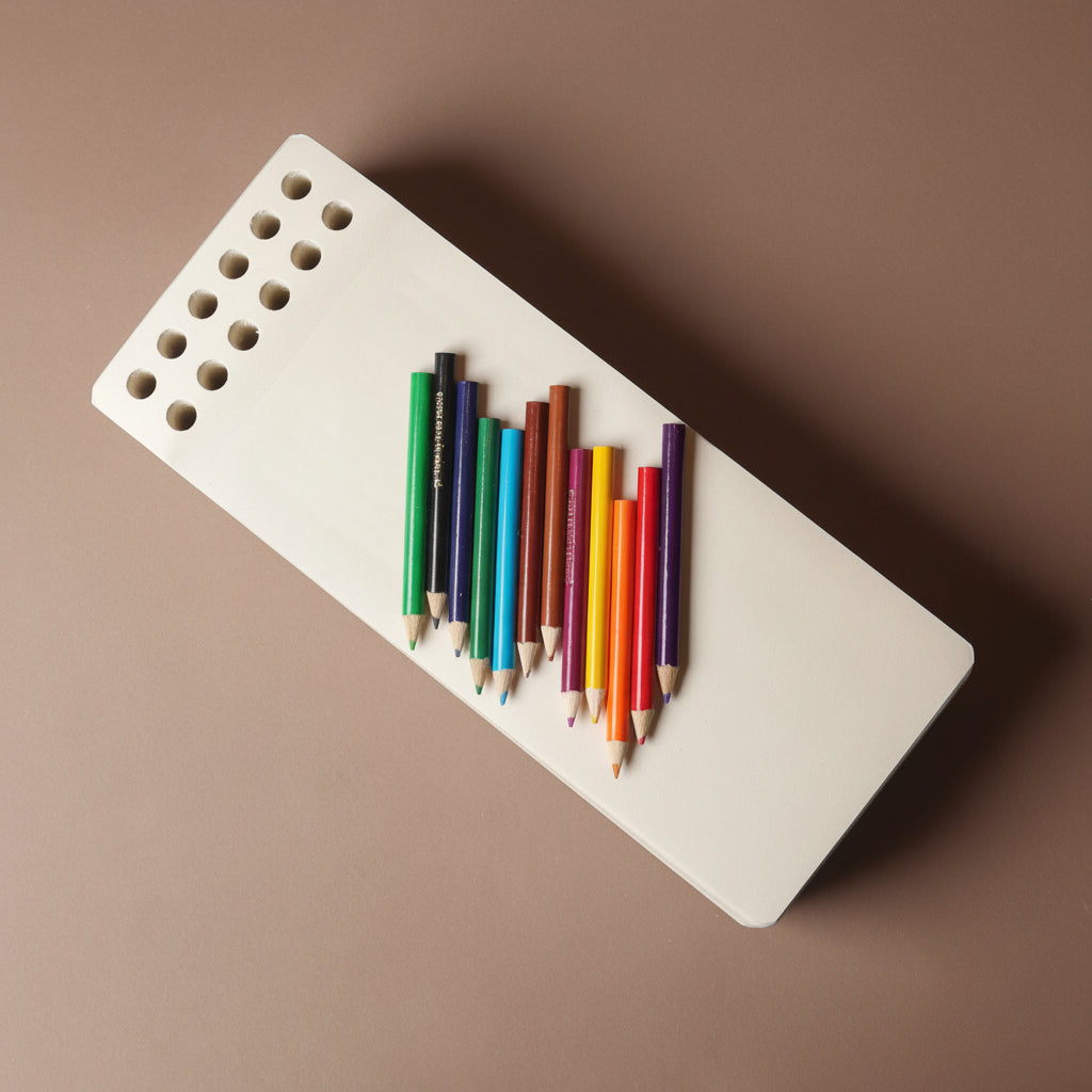 chunky-jotblock-sketch-pad-brick White rectangular paper block with colorful pencils on a brown background