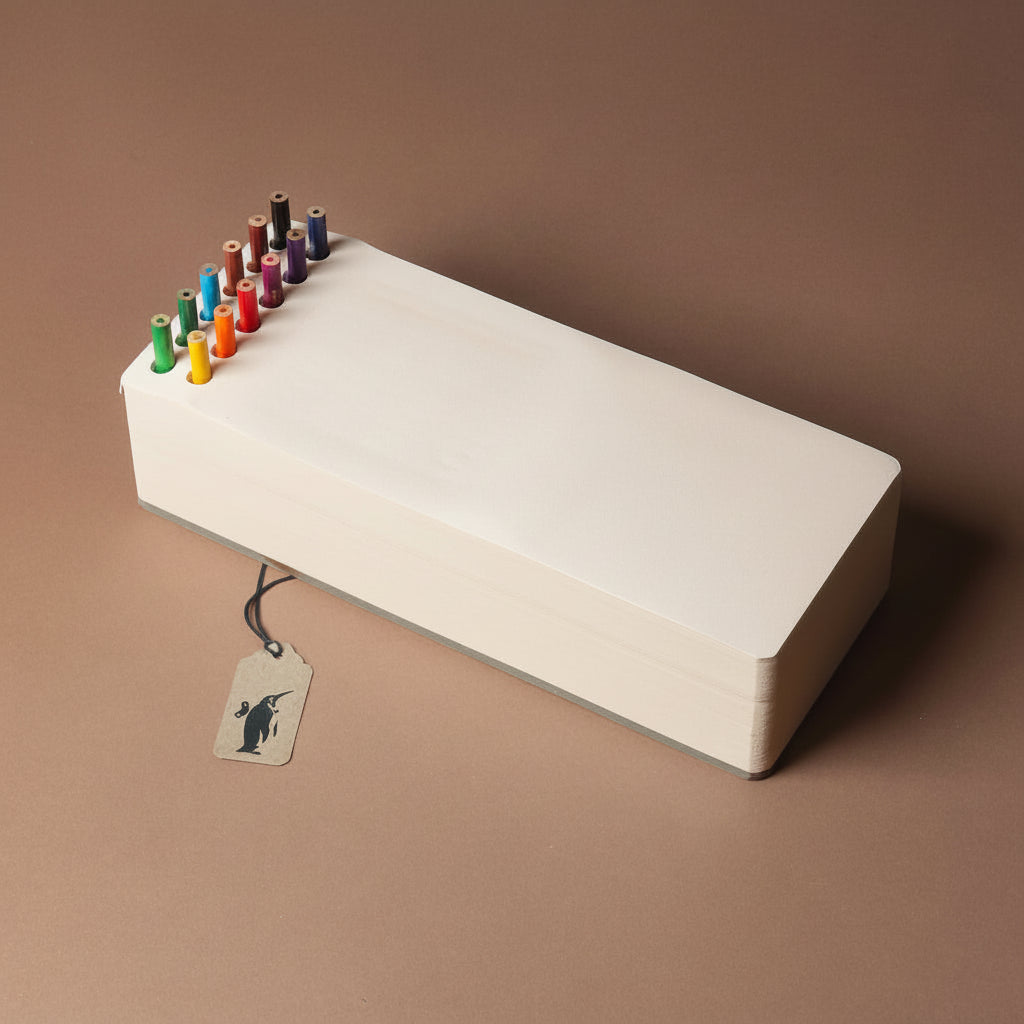 chunky-jotblock-sketch-pad-brick White rectangular paper block with colorful pencils on a brown background