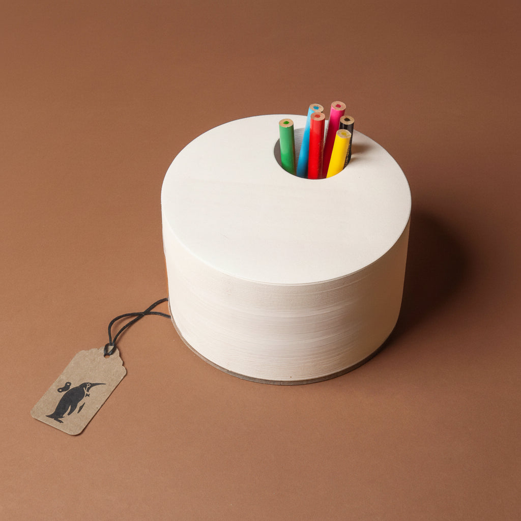 White spool with colorful pencils on a brown background
