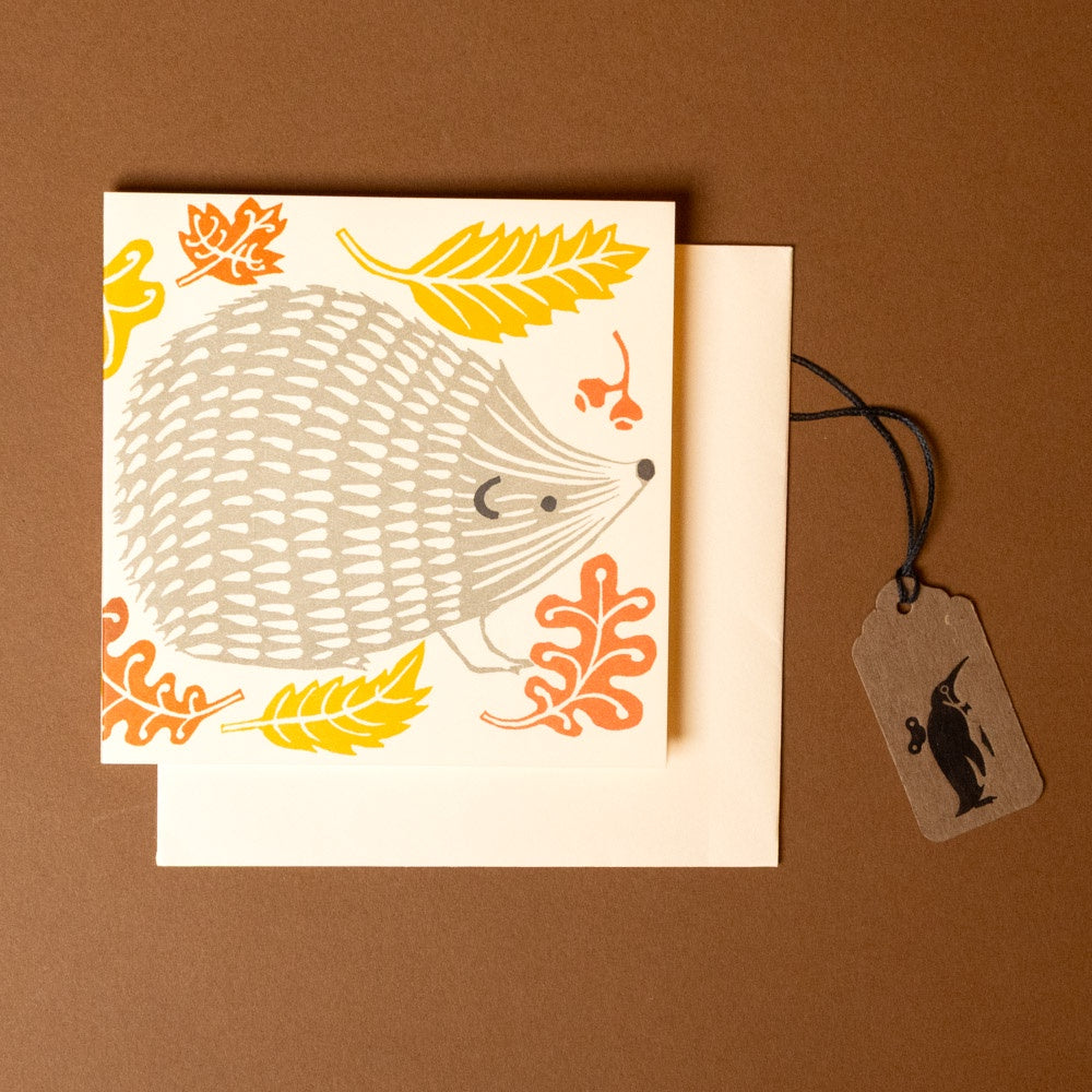 concertina-greeting-card--prickle-of-hedgehogs illustration and leaves on a brown background