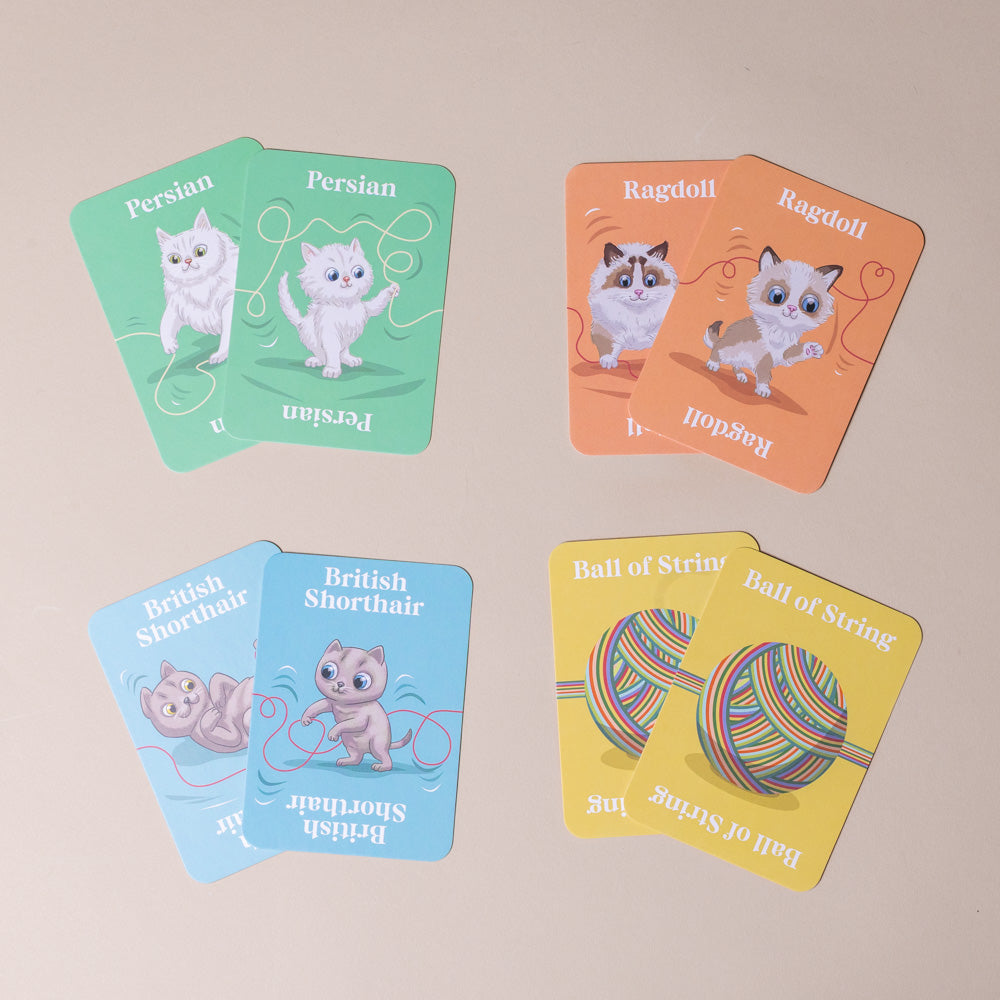 cool-cats--smitten-kittens-family-card-game Set of cards featuring illustrations of cats and a ball of string on a beige background