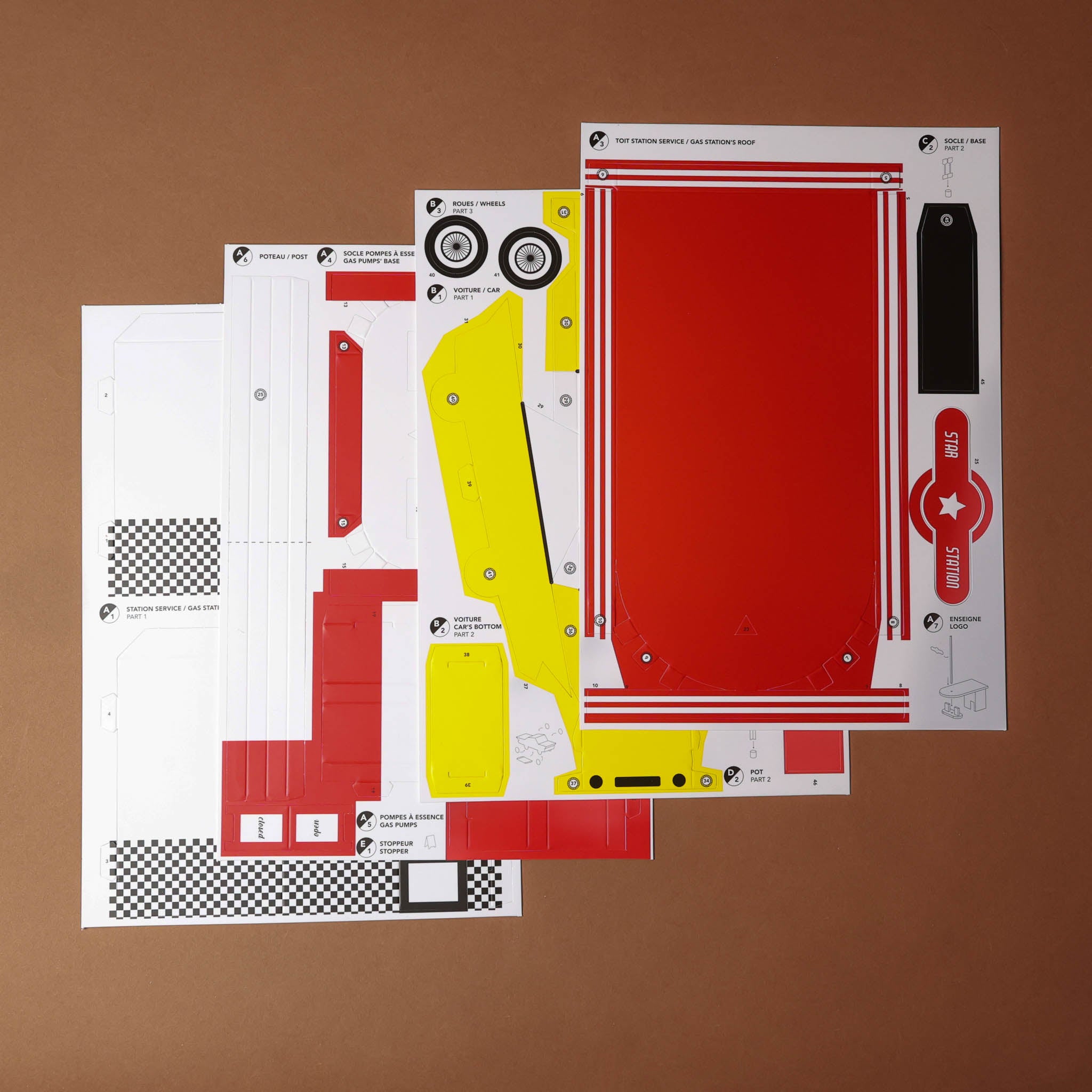 Set of car body panels with red and yellow design on a brown background