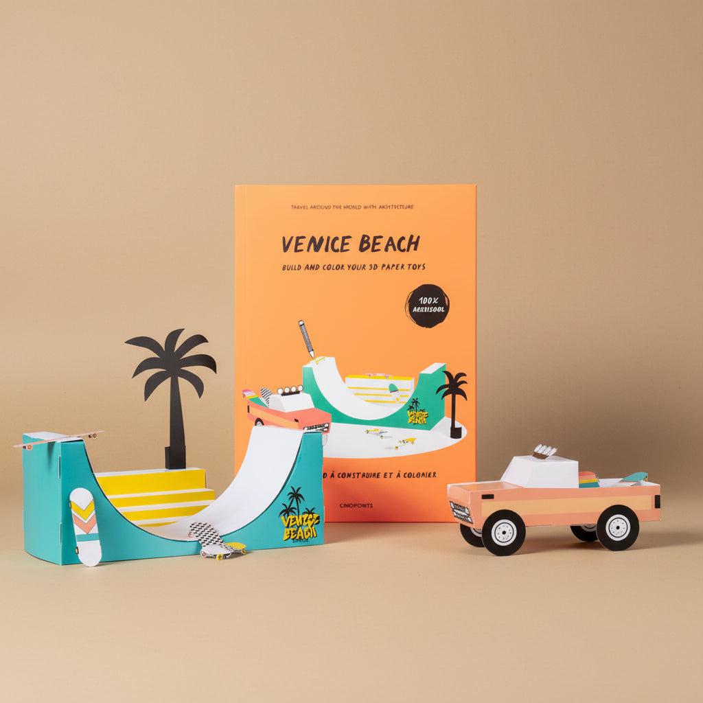 Venice Beach-themed paper toy set with a book on a white background