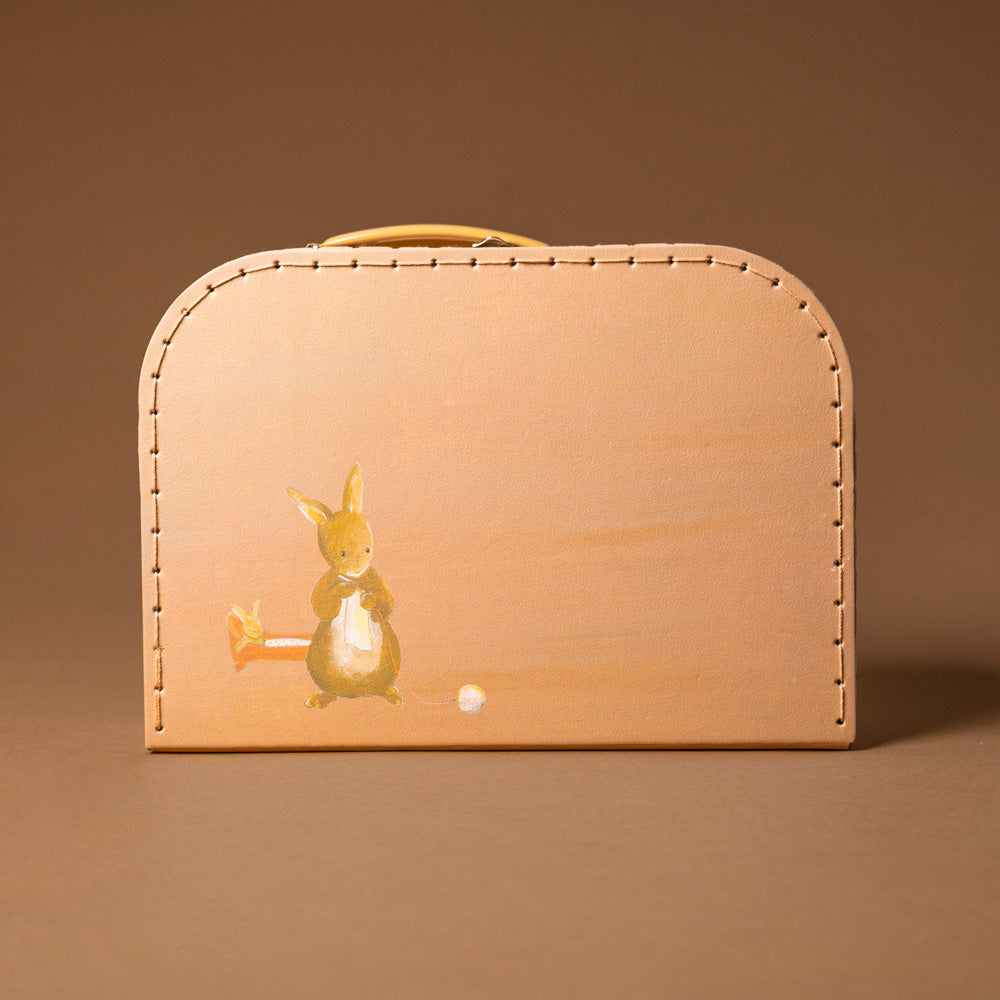 Small suitcase with a rabbit design on a brown background