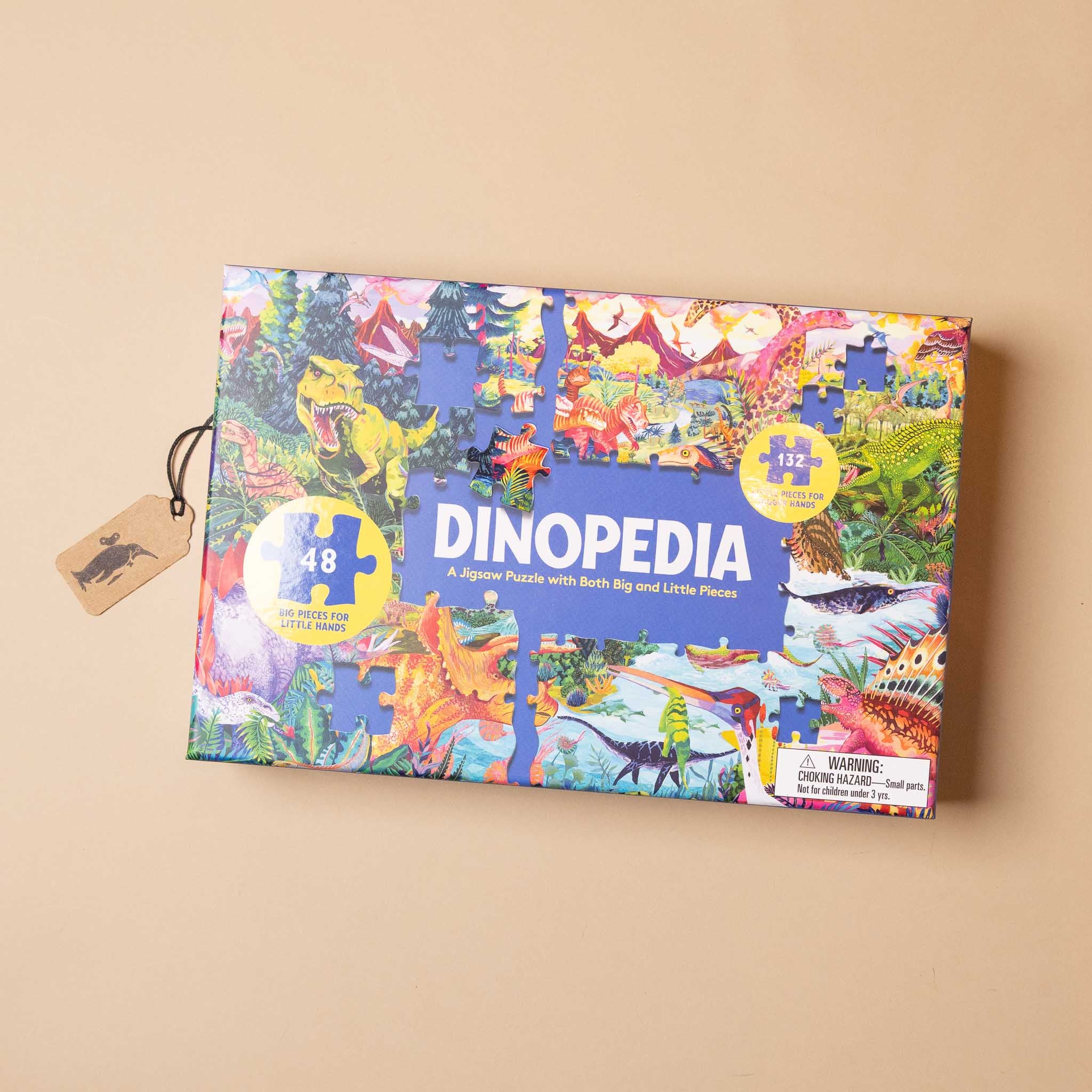 Dinopedia puzzle box with colorful dinosaur illustrations on a beige background