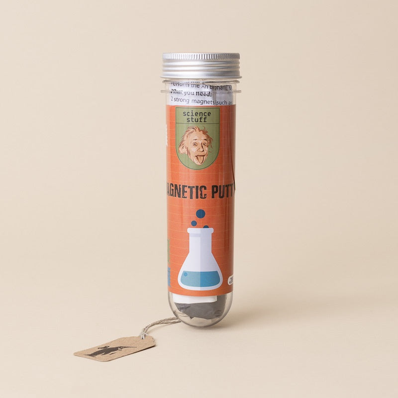 A clear cylindrical plastic tube with a silver cap containing magnetic putty, standing on a beige background. The tube has an orange label featuring a vintage-style portrait of Albert Einstein and the text 'science stuff' and 'MAGNETIC PUTTY'.