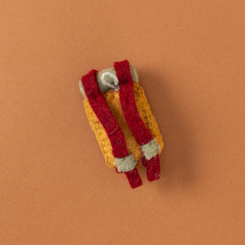 A small handmade felt backpack in mustard yellow, red, and light gray, with two metal buttons on top