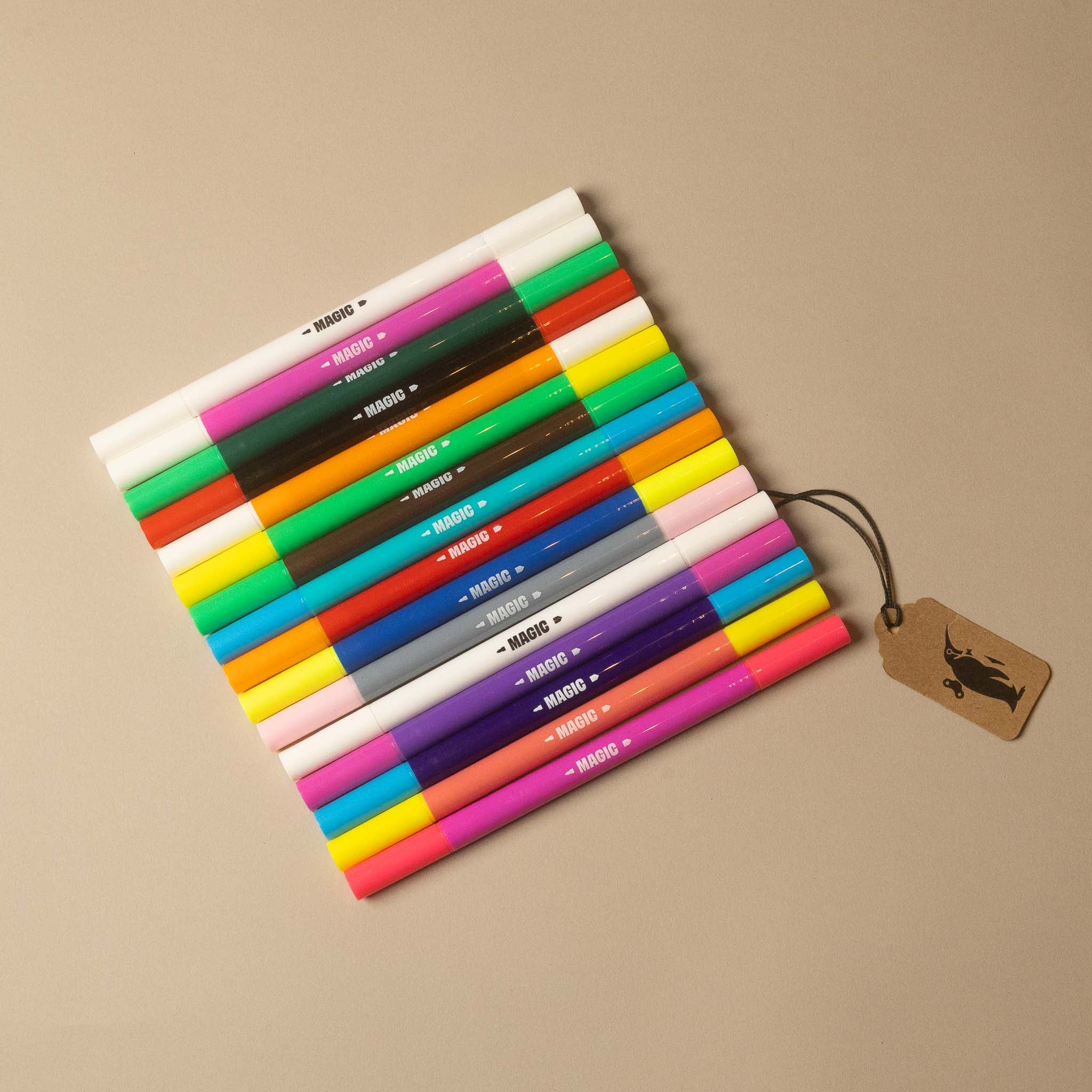 A set of 16 double-tip gel pens in various colors, arranged in a fan shape on a beige background with a small brown paper tag attached.