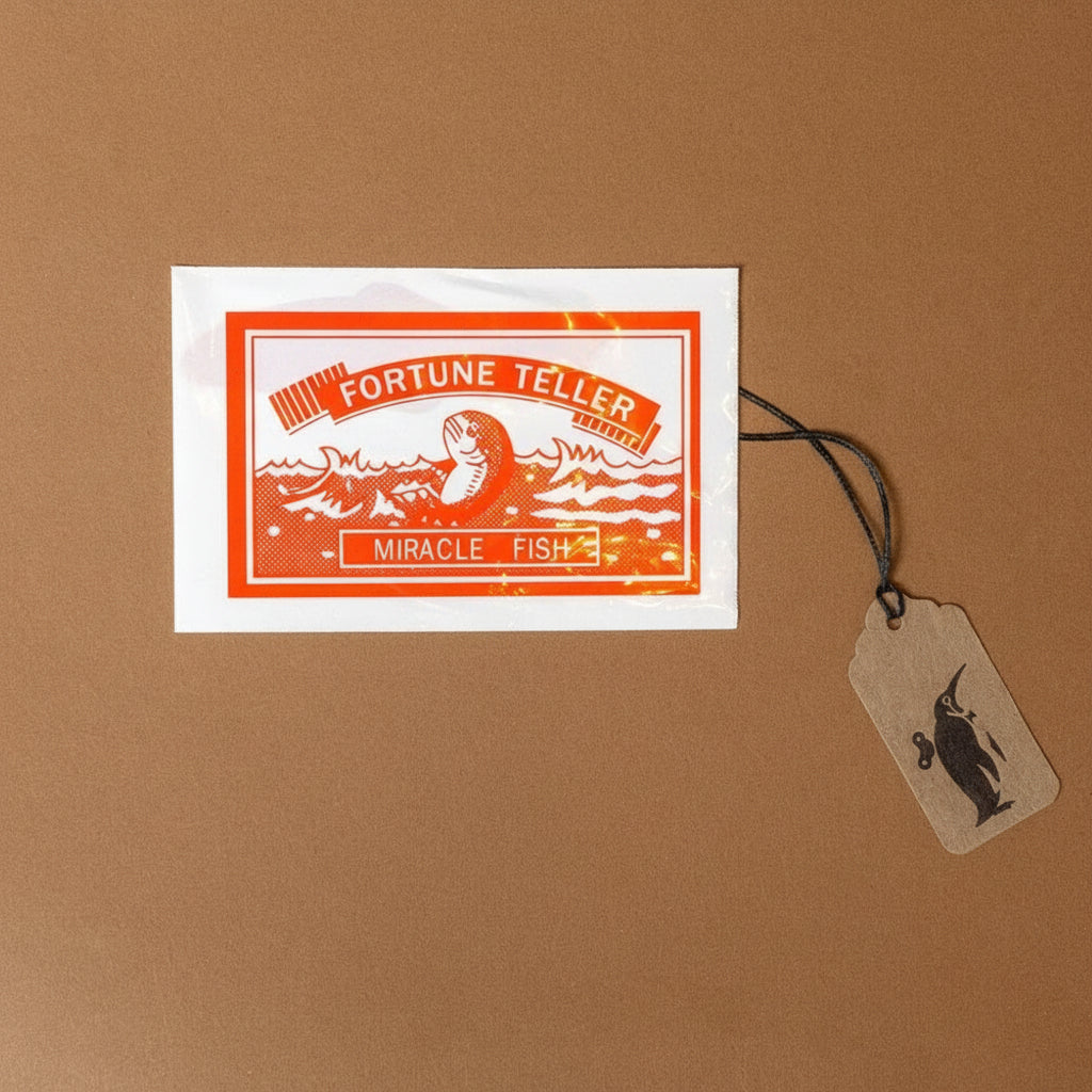 Fortune Teller Miracle Fish packaging on a brown background