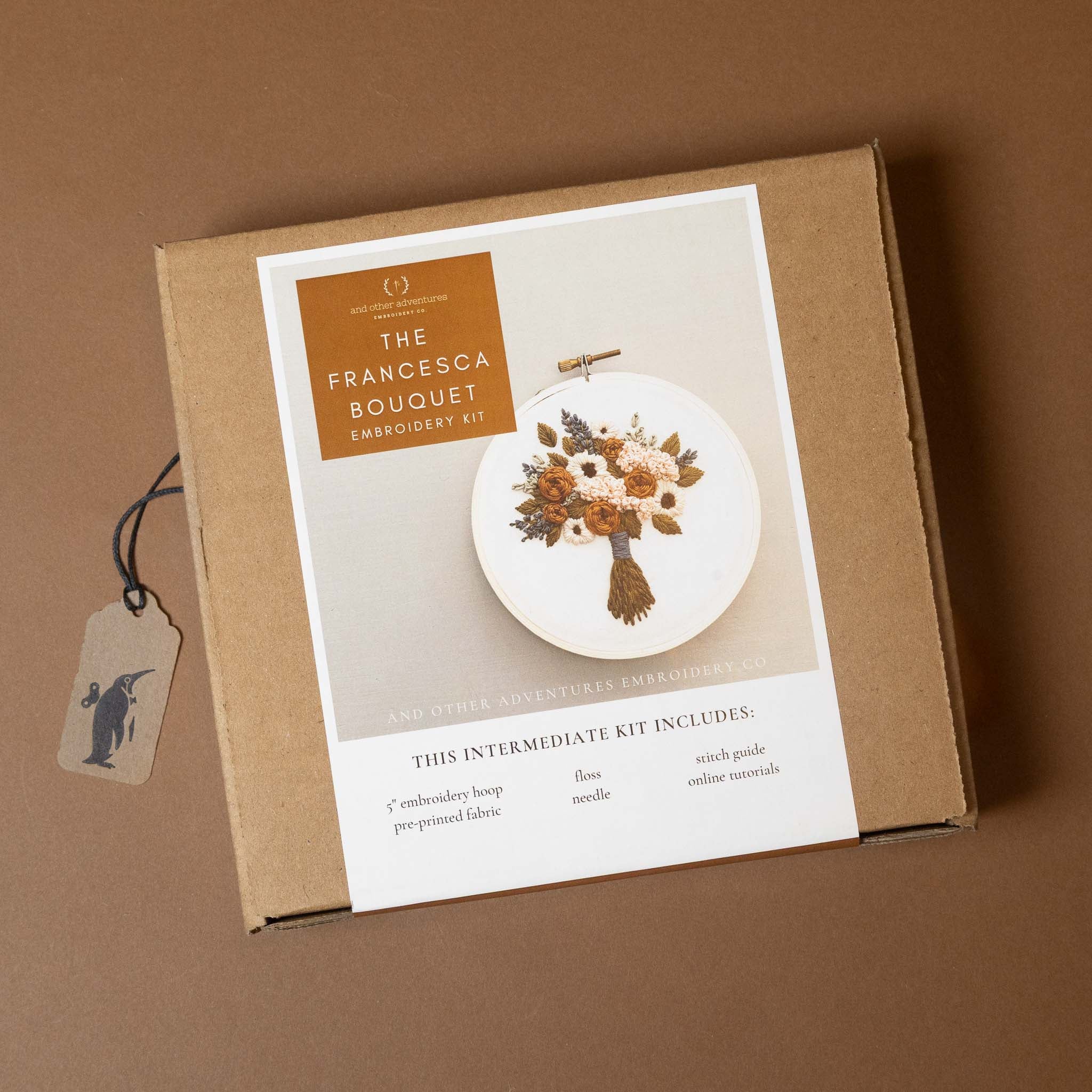 francesca-bouquet-embroidery-kit packaging with a tag on a brown background