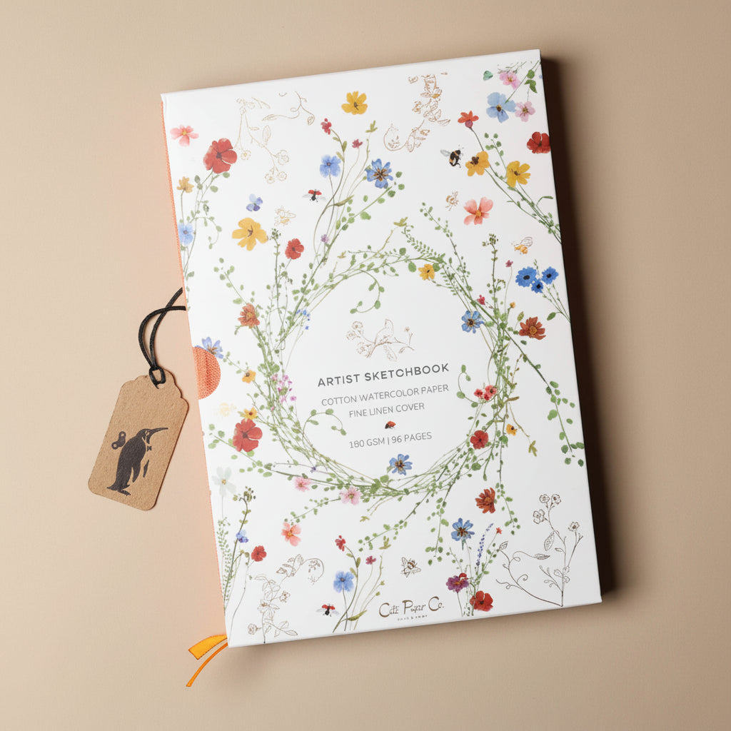 Floral design artist sketchbook with a tag on a beige background