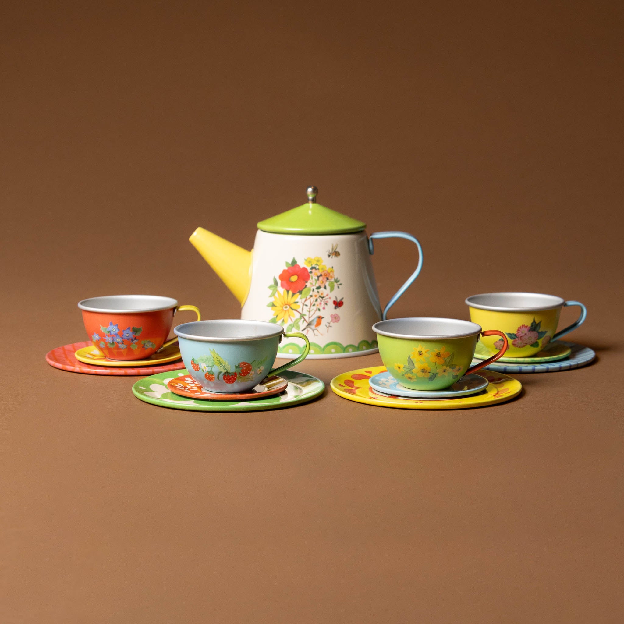 grande-famille-tea-set Colorful teapot and cups set on a brown background