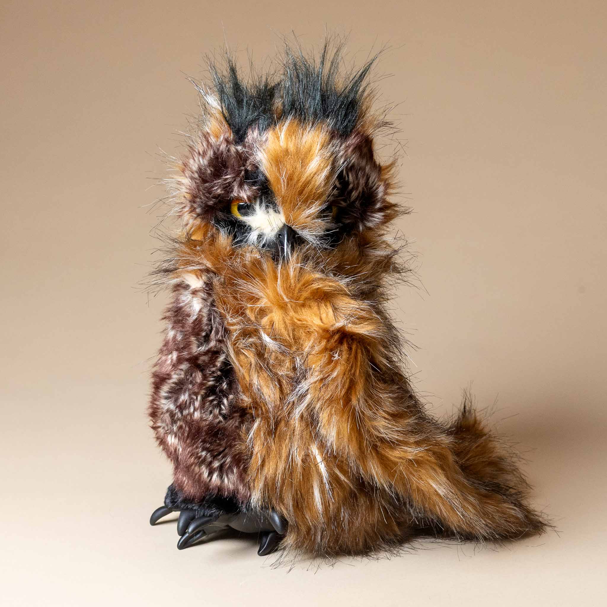 great-horned-owl-hand-puppet Plush toy owl with brown and black feathers on a beige background