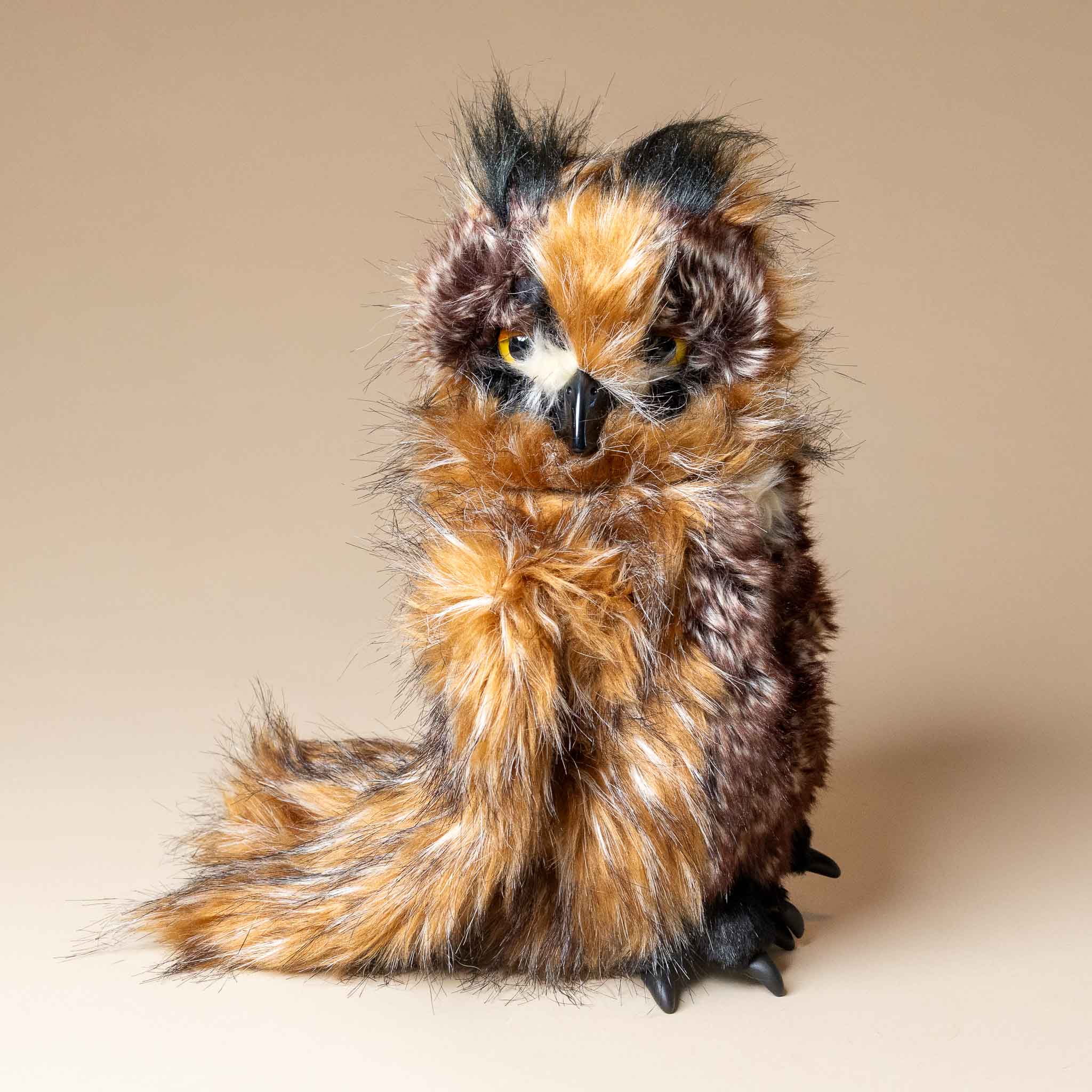 great-horned-owl-hand-puppet Plush toy owl with brown and black feathers on a beige background