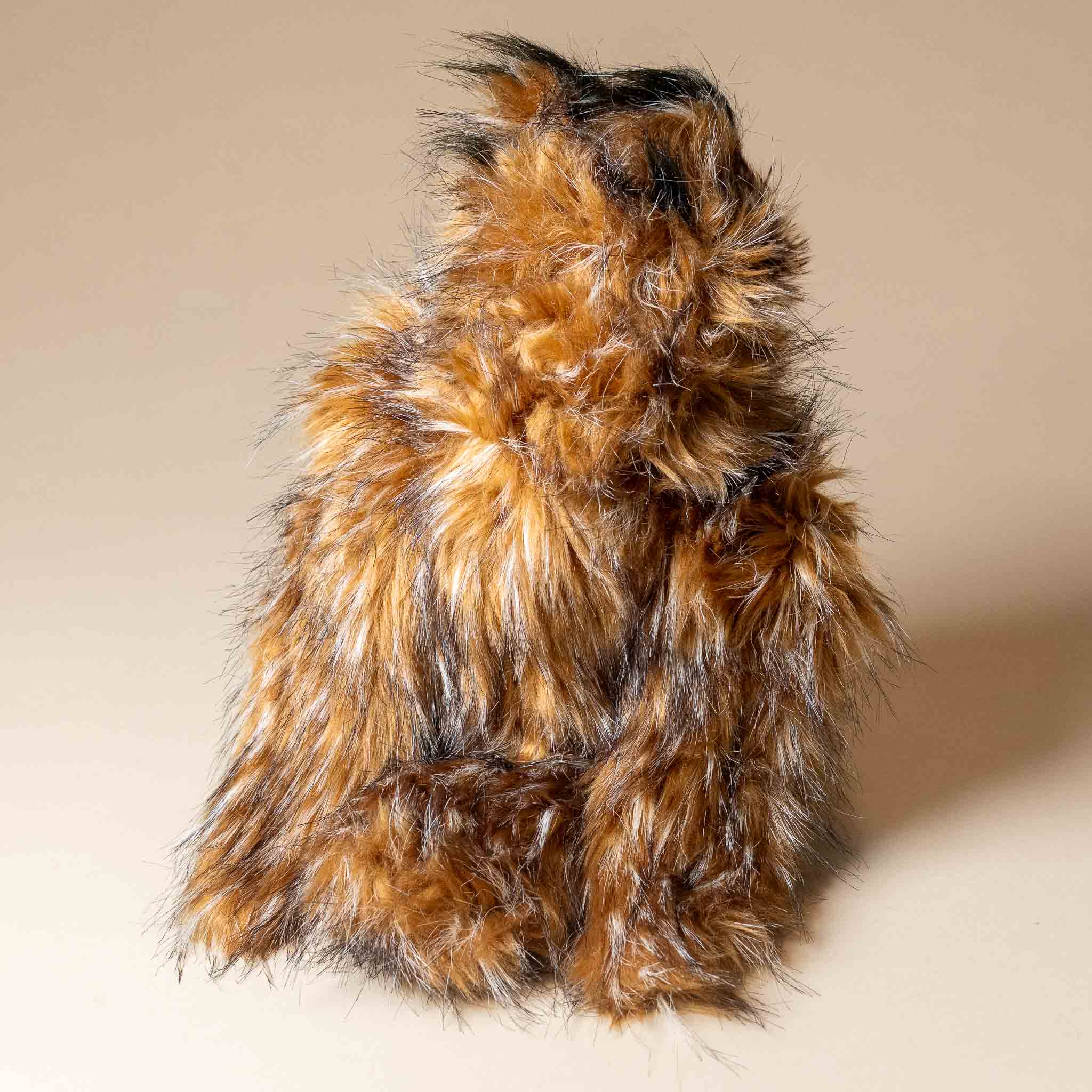 great-horned-owl-hand-puppet Brown feather-like coat on a beige background