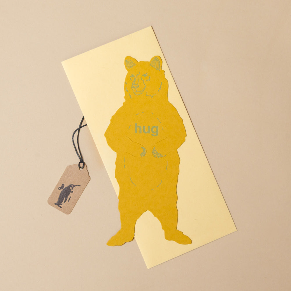 grizzly-bear-letterpress-gift-greeting-card Yellow bear-shaped card with 'hug' text on a beige background