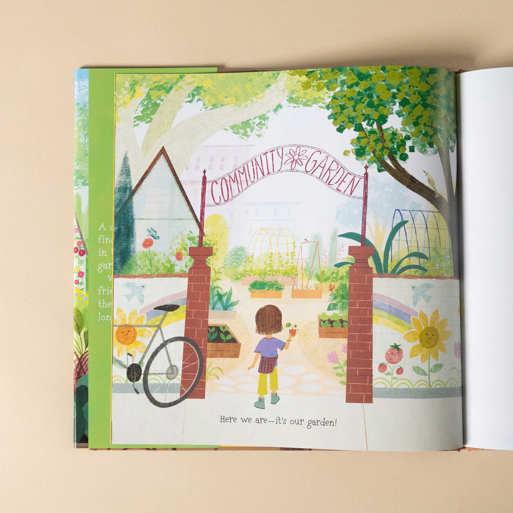 Illustrated book open to a page showing a community garden with a child and bicycle.