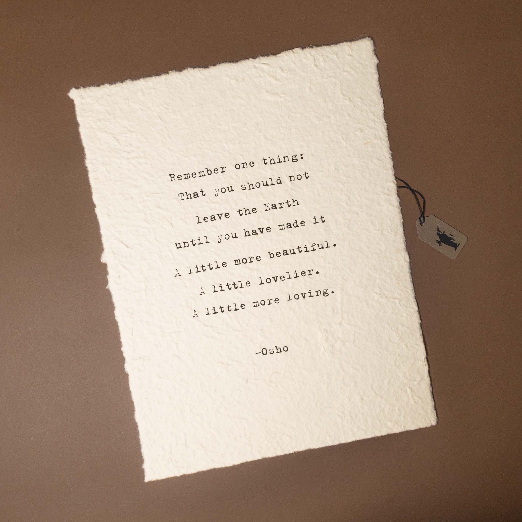 Text on a textured white paper with a tag on a brown background
