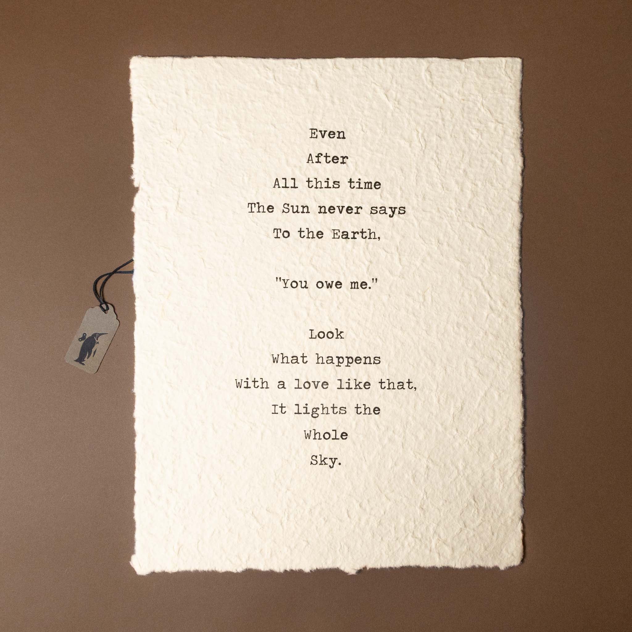 Text on a textured paper with a tag on a brown background