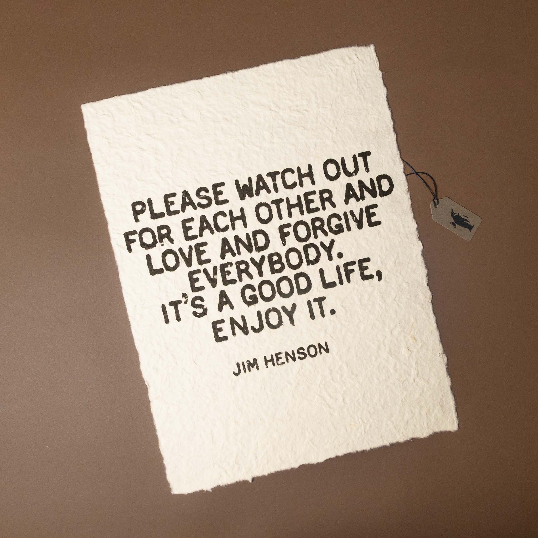 Textile with a quote by Jim Henson on a brown background